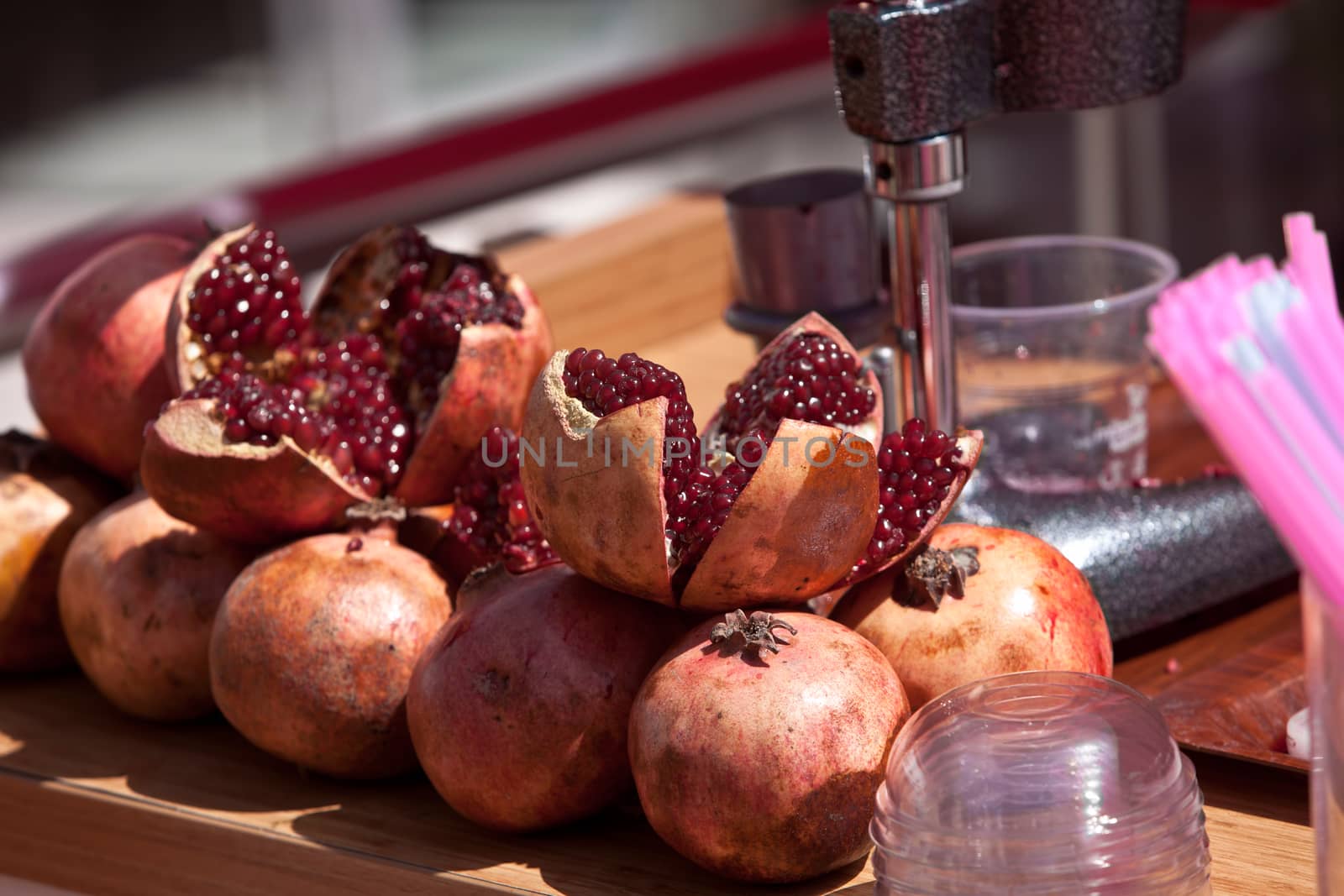 Split pomegranates ready to be juiced on Turkish street vendor table