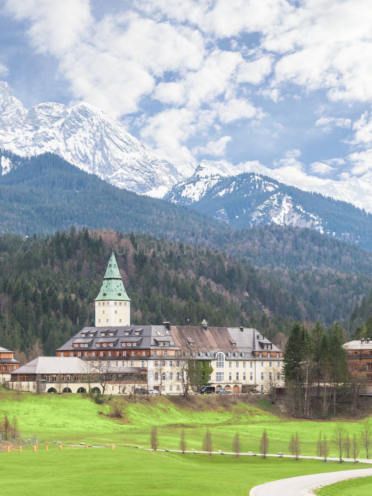 Klais, Germany - April 26, 2015: Hotel Schloss Elmau palace in Bavarian Alps will be the site of the 41st international forum G7 summit at June 7-8 2015. Vertical landscape with Alpine mountains and valley.