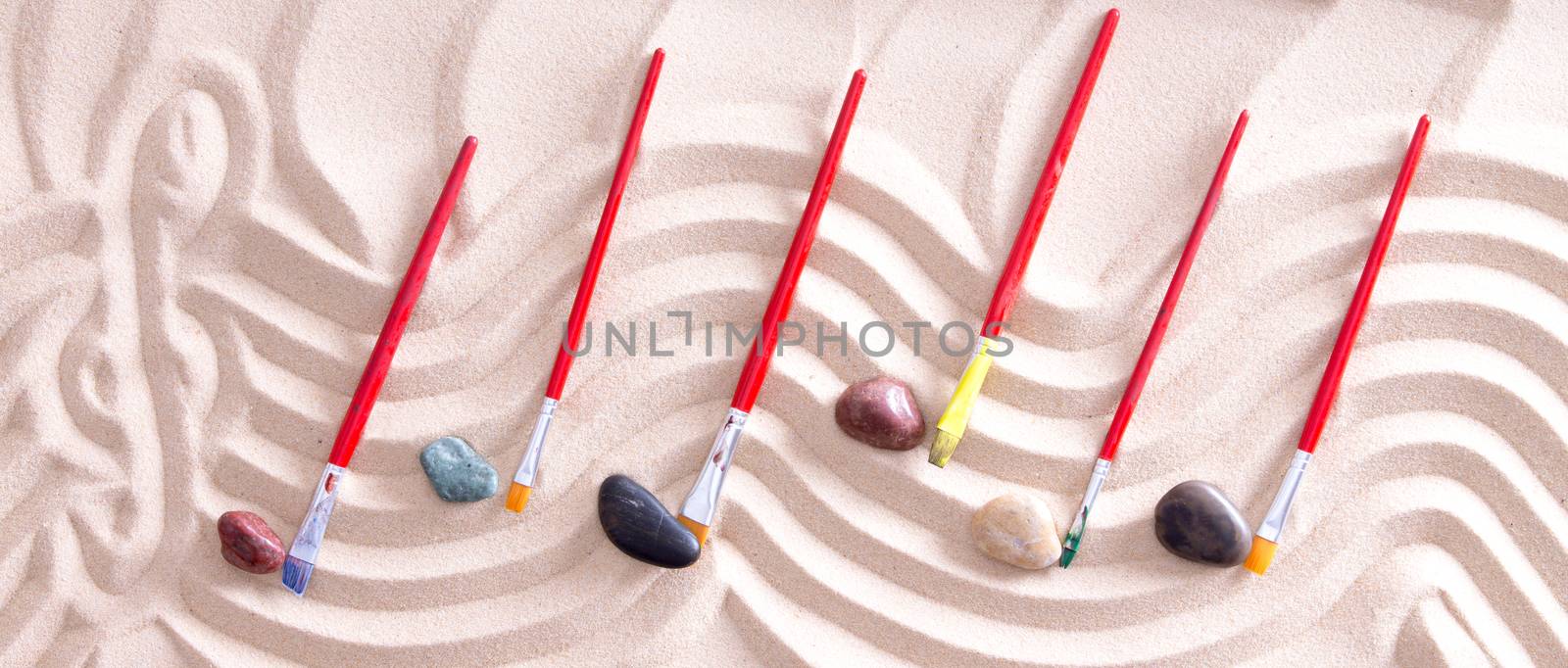 High Angle View of Music Staff with Treble Cleff Drawn Into Sand and Paintbrushes and Stones for Music Notes, Creating Music on Beach with Nature and Artistic Inspiration