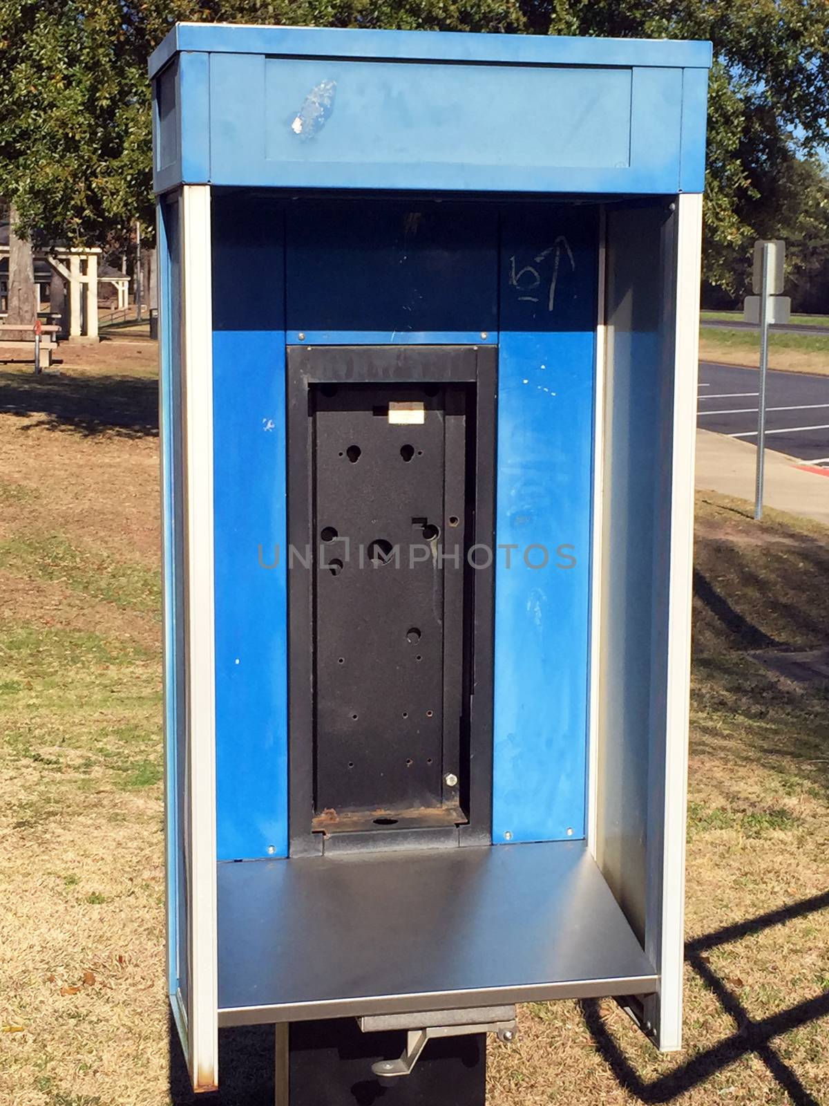 Abandoned public telephone booth.  Pay phones are increasingly being removed due to their low usage, having been replaced by cell phones.