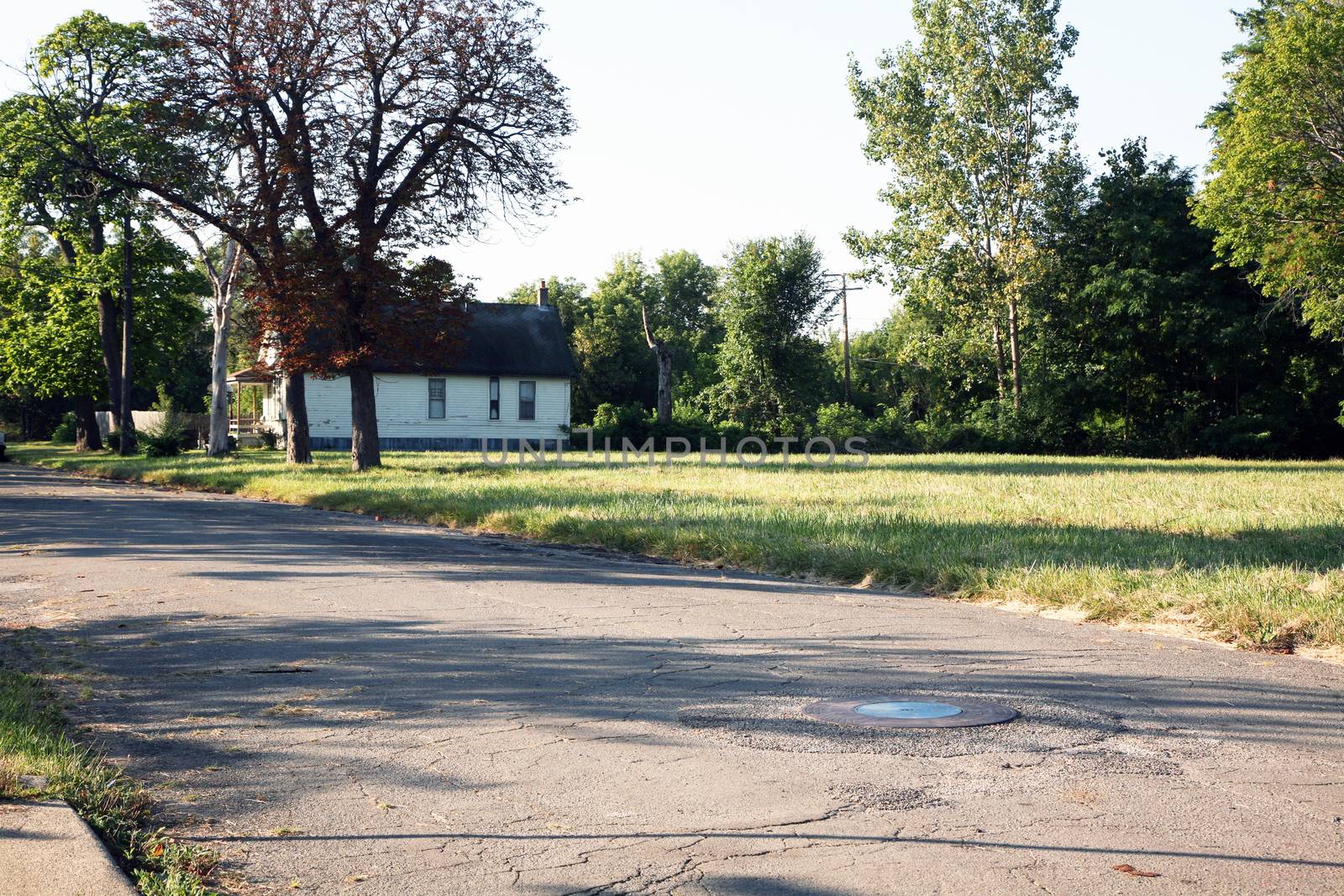 Abandoned urban neighborhood with only one home left standing showing the isolation and dangers.