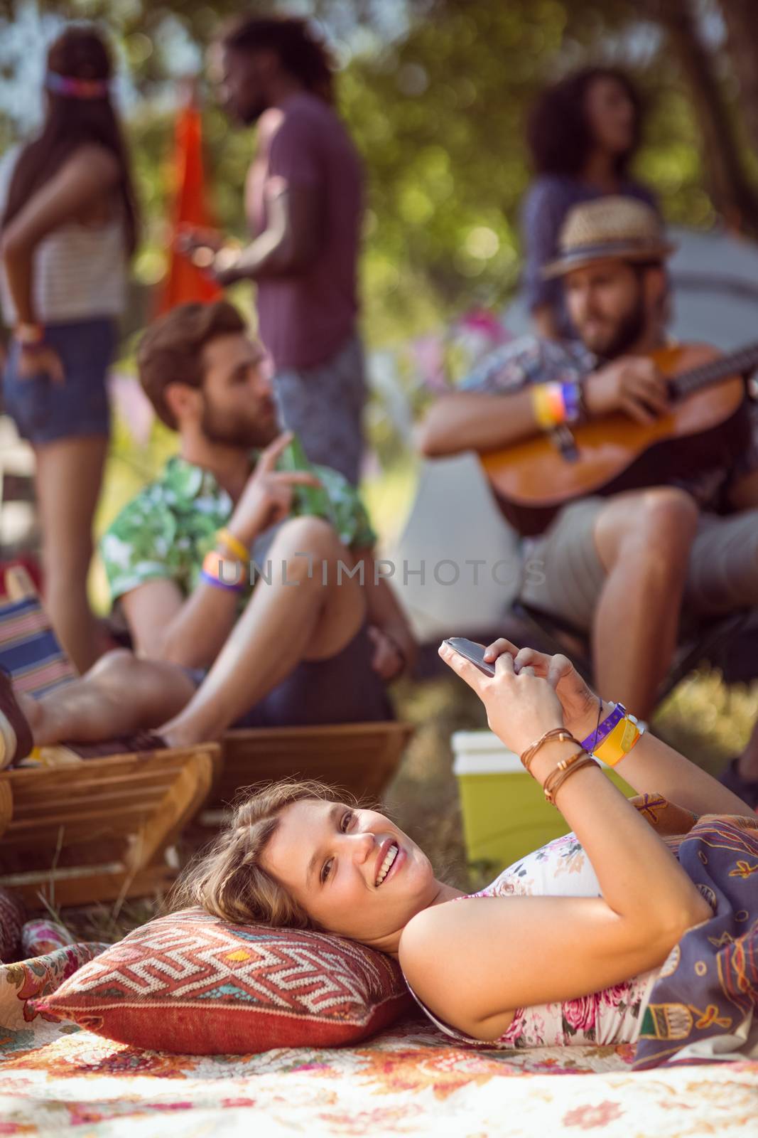 Pretty hipster relaxing on campsite at a music festival 