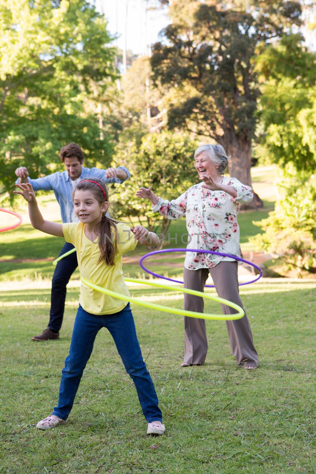 Extended family playing with hula hoops by Wavebreakmedia