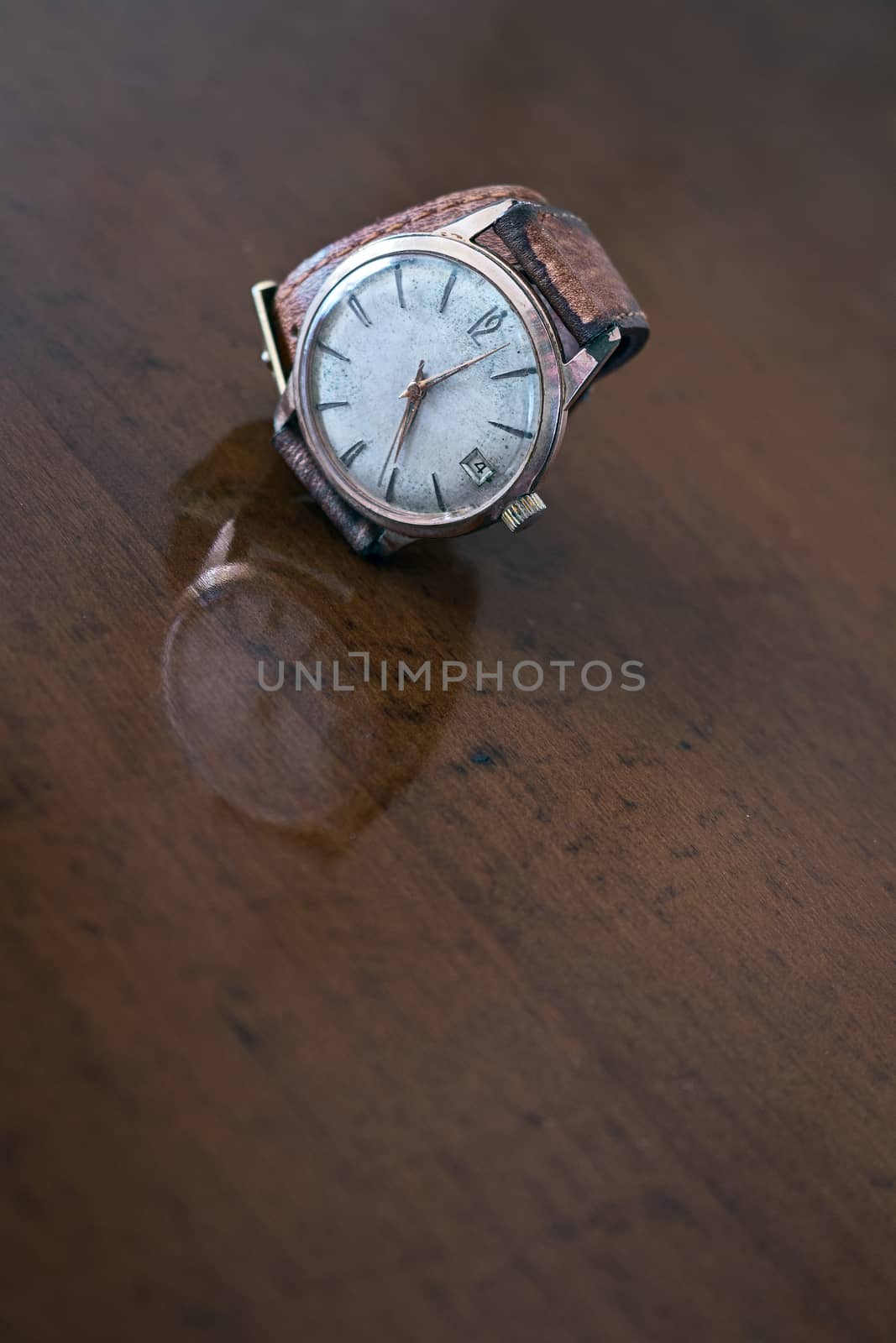 old wrist watch on a wooden base