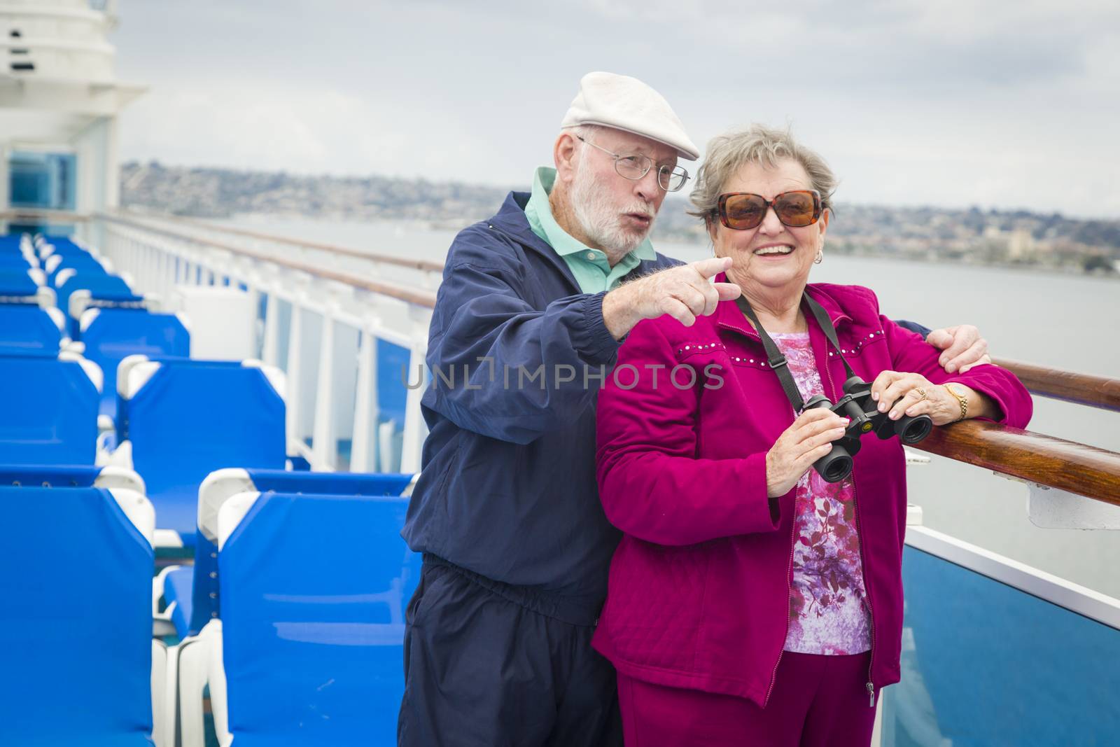 Senior Couple Enjoying The Deck of a Cruise Ship by Feverpitched