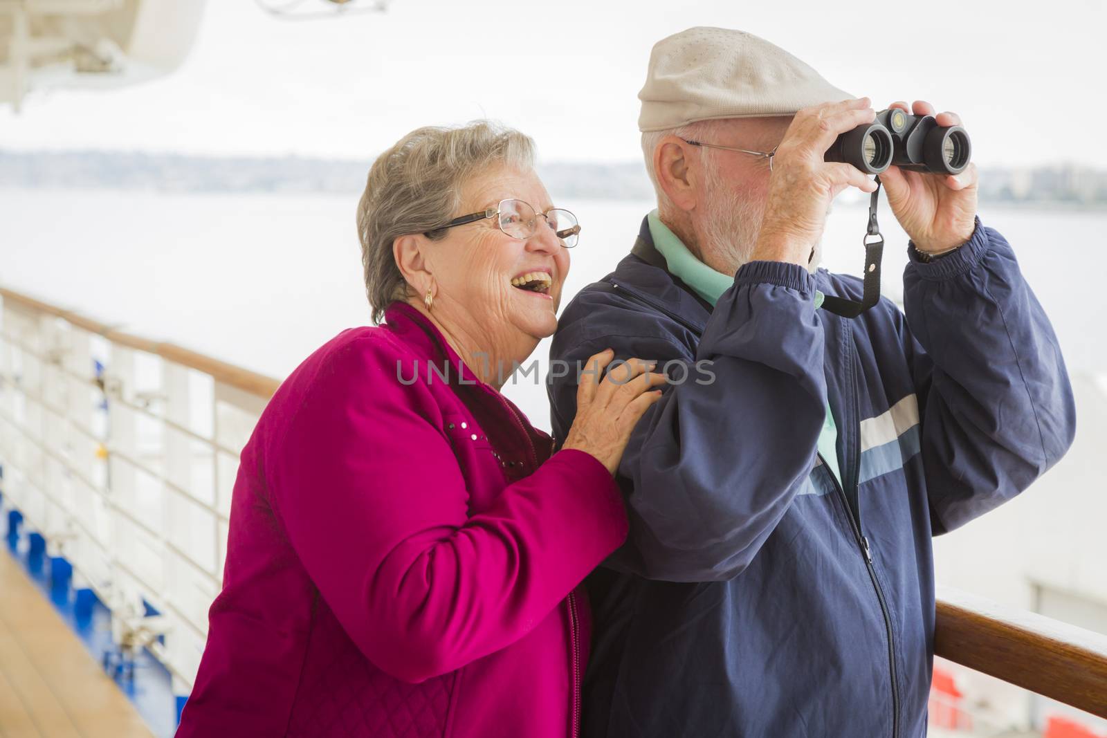 Senior Couple Enjoying The Deck of a Cruise Ship by Feverpitched