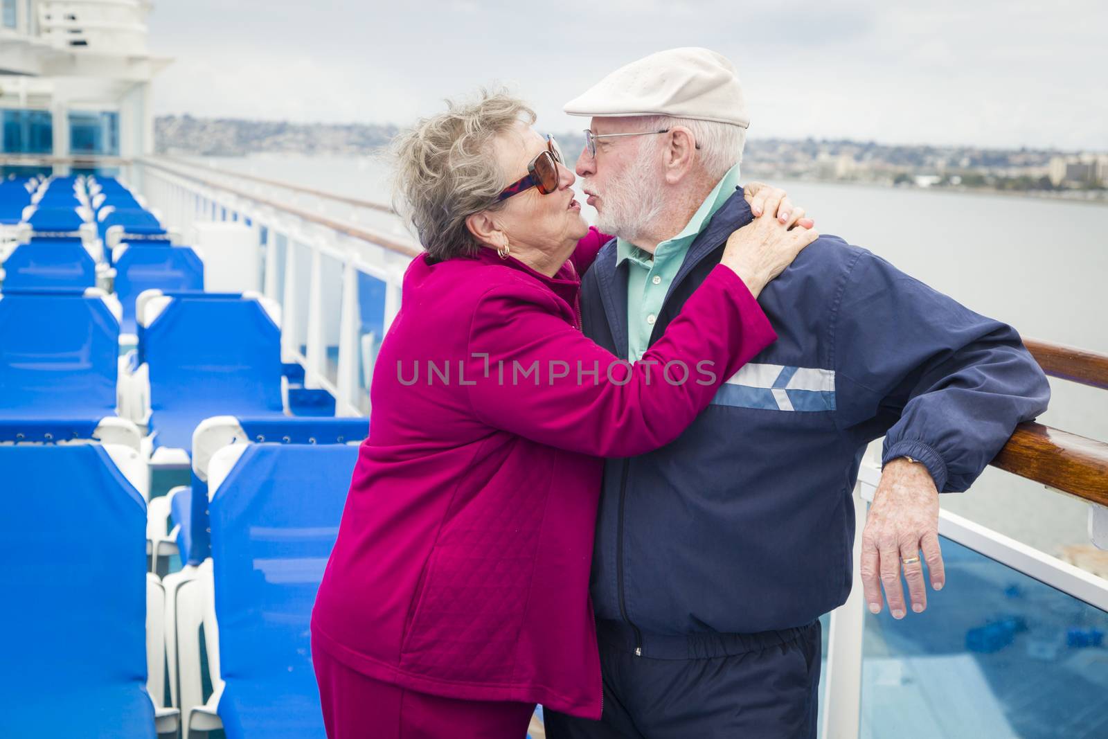 Senior Couple Kissing on Deck of Cruise Ship by Feverpitched