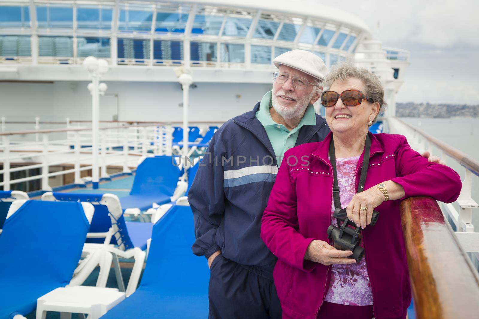 Senior Couple Enjoying The Deck of a Cruise Ship by Feverpitched