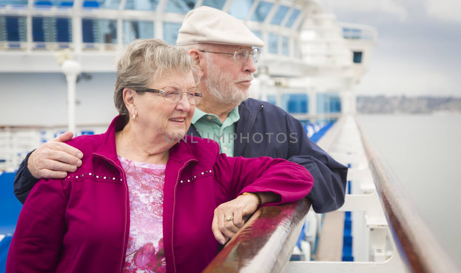 Senior Couple Enjoying The Deck of a Cruise Ship by Feverpitched