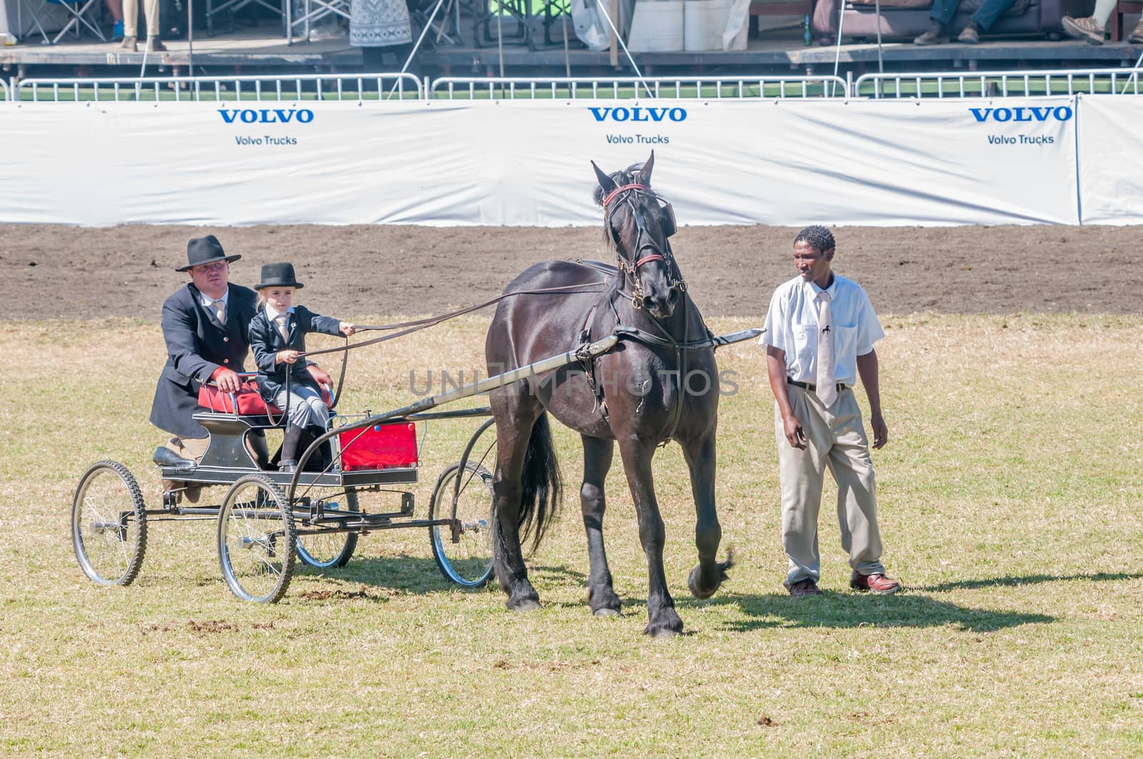 BLOEMFONTEIN, SOUTH AFRICA - APRIL 28, 2015: Young girl and father on a horse-drawn cart during the South African National Championships at the Bloem Show