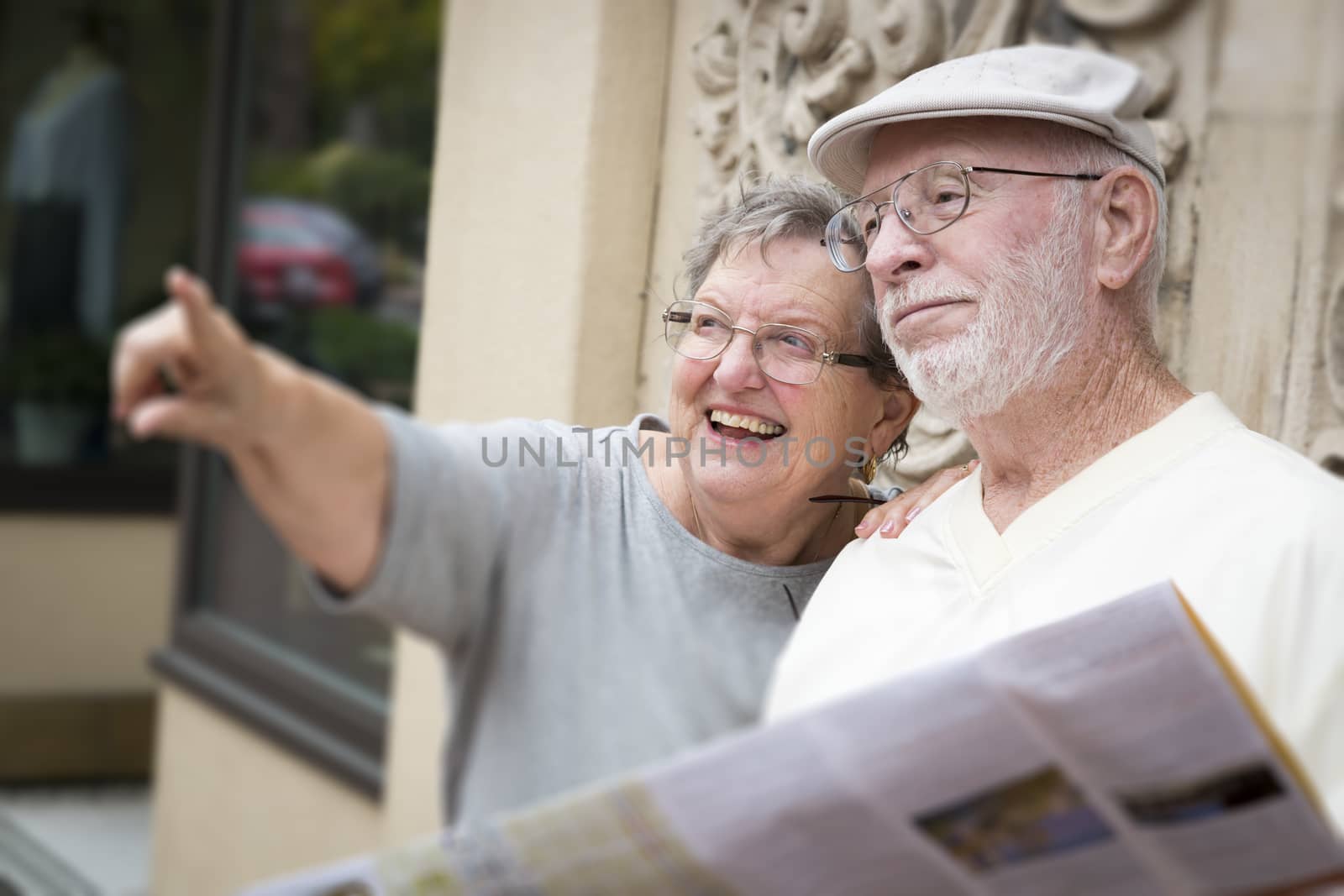 Tourist Senior Couple Looking at Brochure Map by Feverpitched