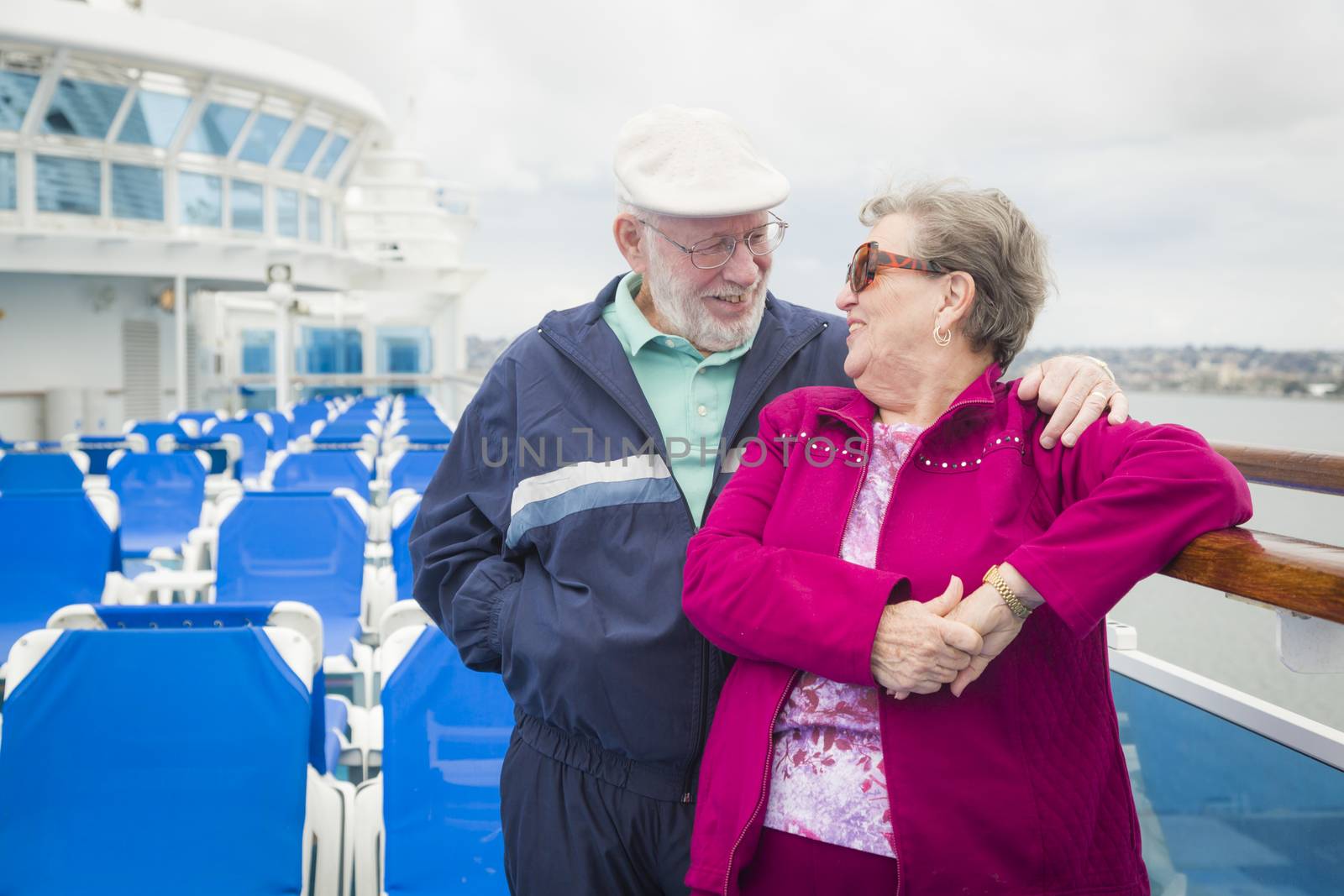 Senior Couple Enjoying The Deck of a Cruise Ship by Feverpitched