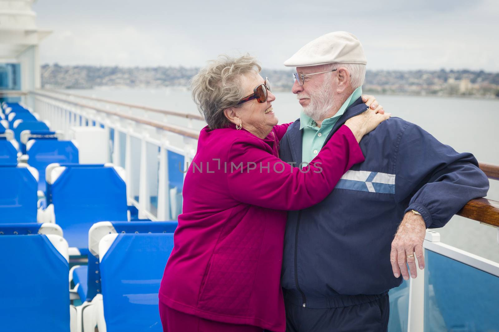 Senior Couple Enjoying The Deck of a Cruise Ship by Feverpitched