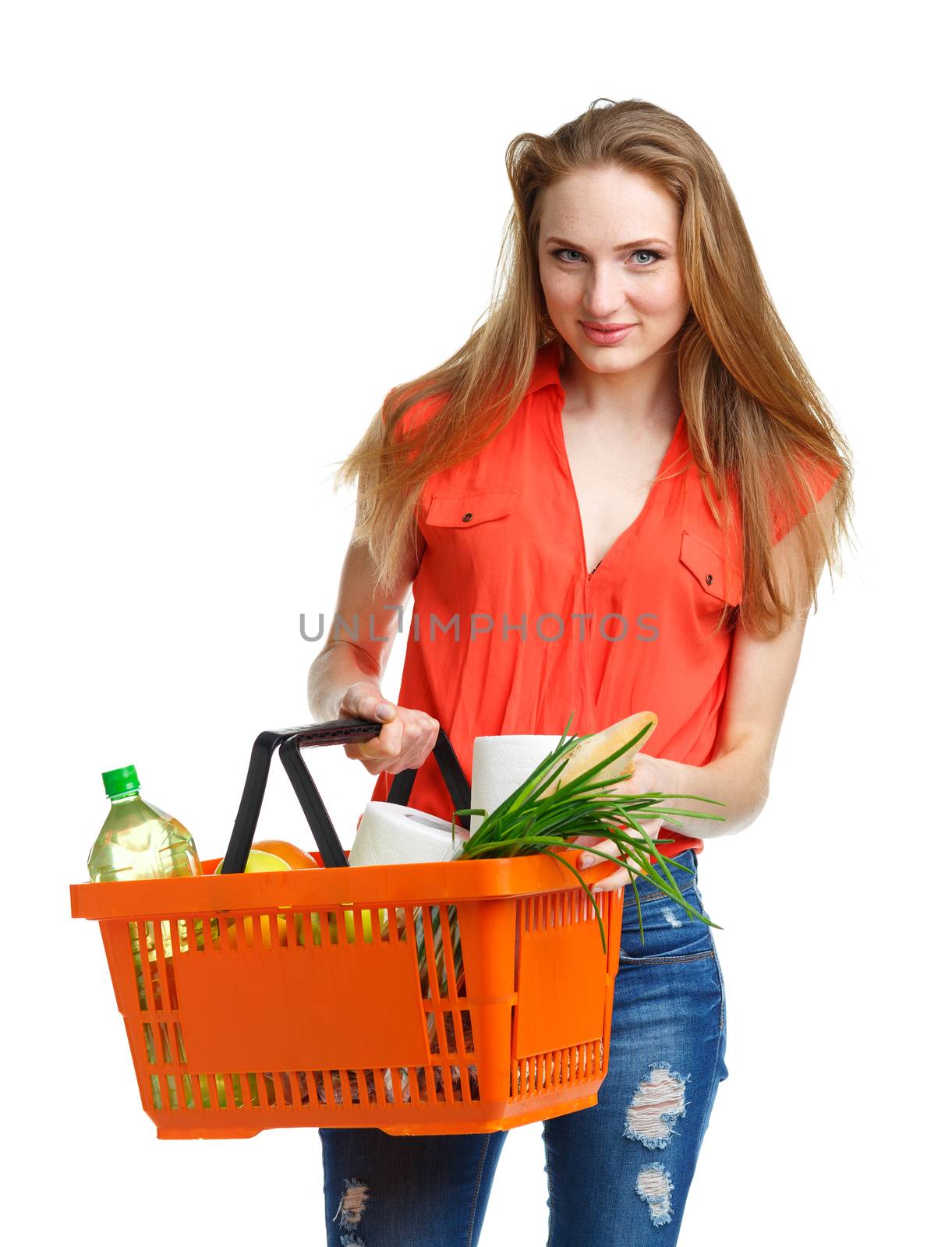 Happy young woman holding a basket full of healthy food. Shopping