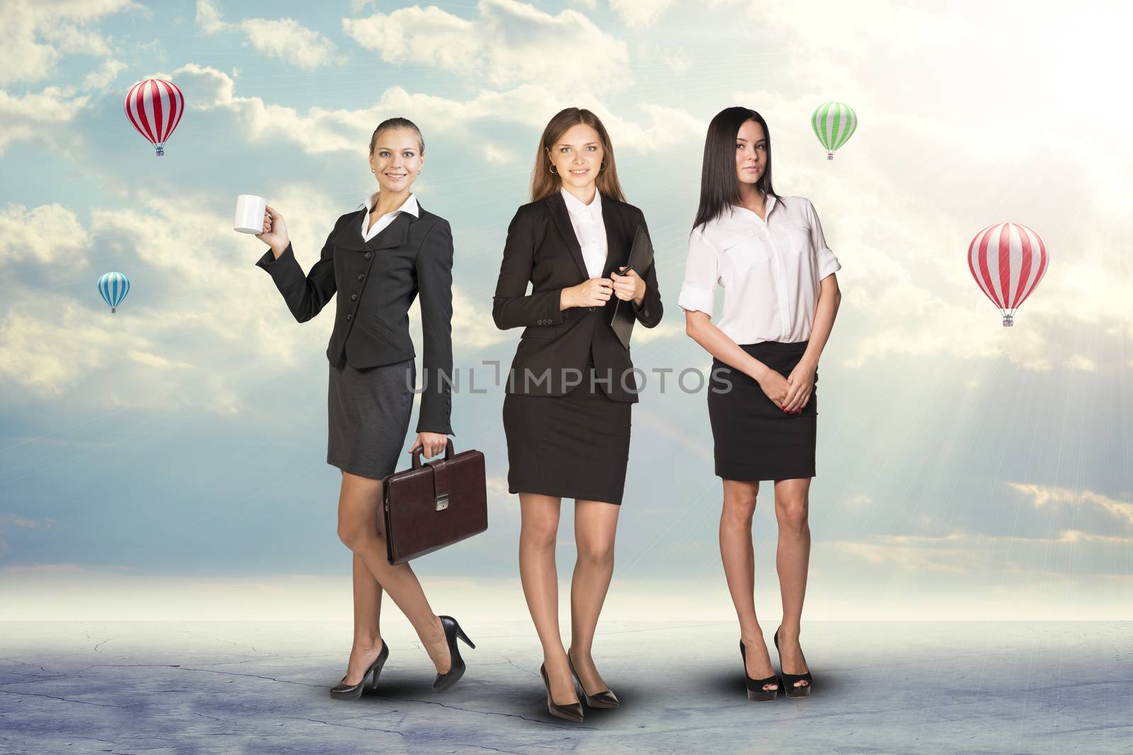 Group of smiling businesswomen looking at camera on abstract background