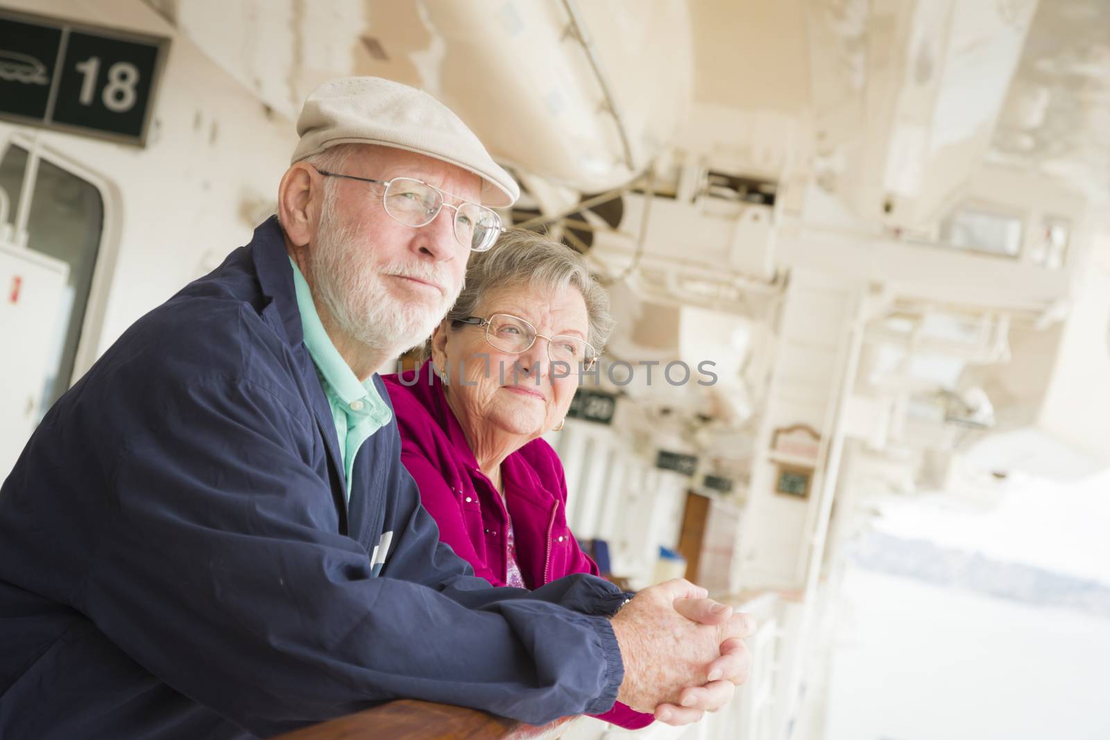 Happy Senior Couple Enjoying The View From Deck of a Luxury Passenger Cruise Ship.