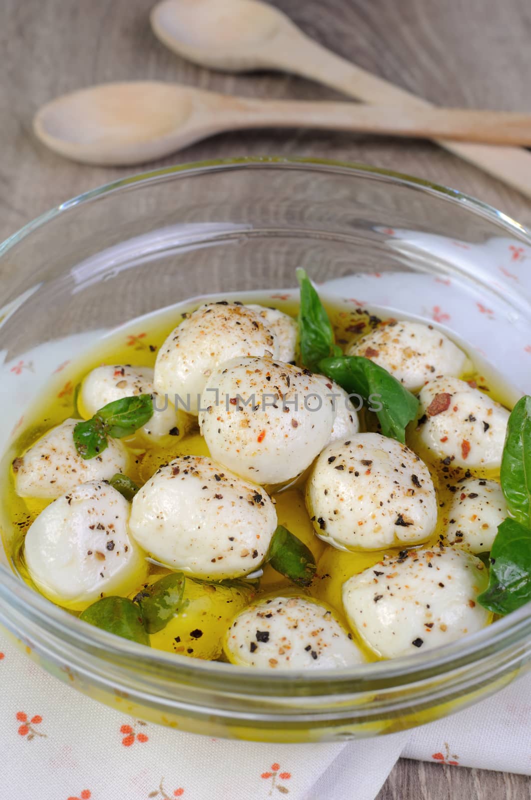 Baby mozzarella in olive oil with herbs 