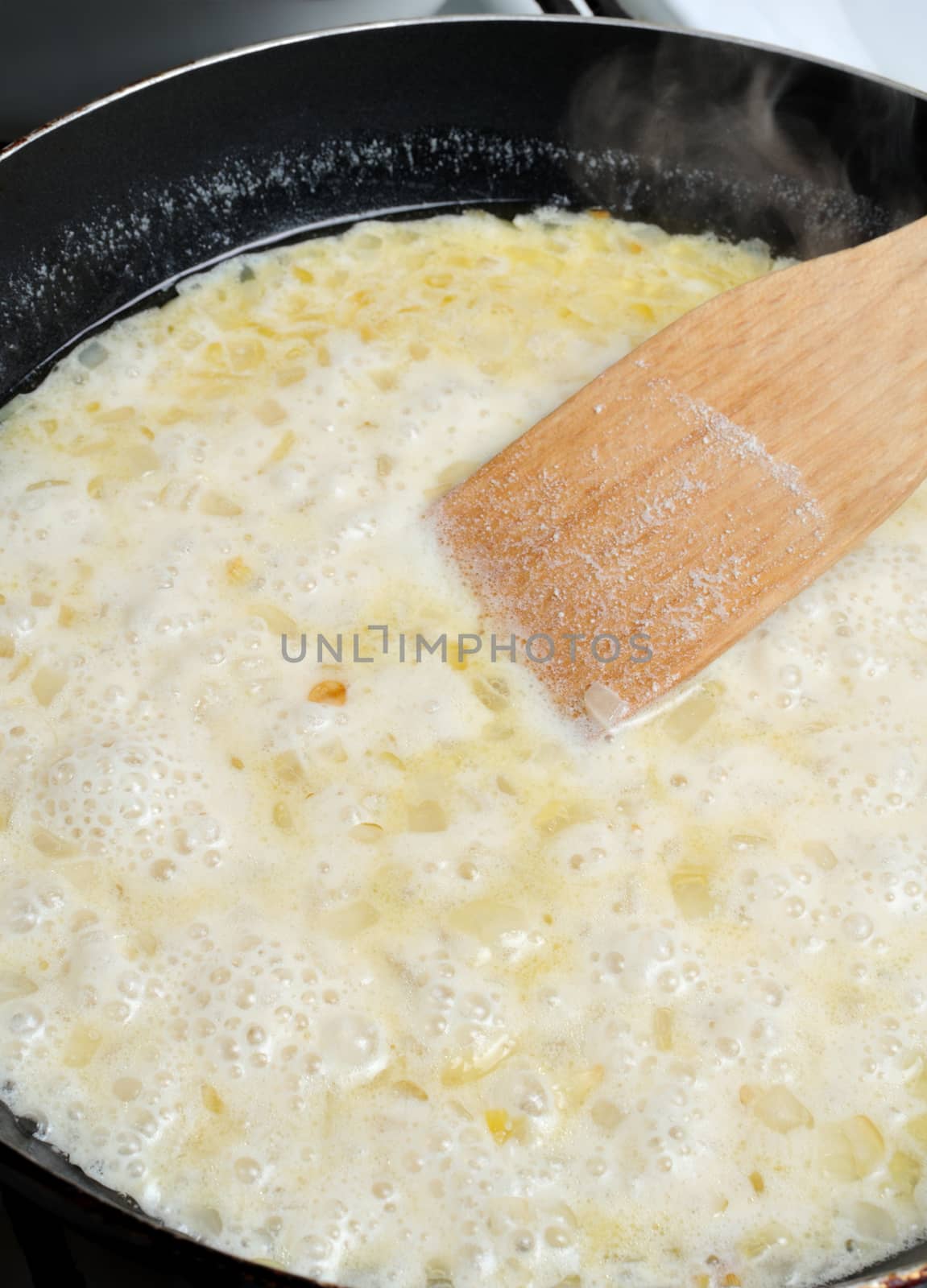  Boiling cream added to the pan to cook the sauce