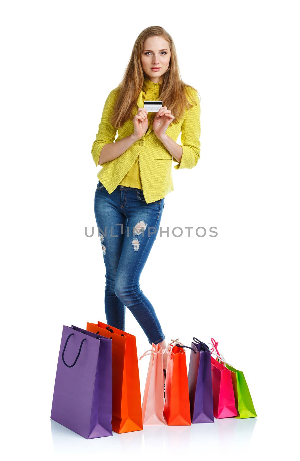 Shopaholic woman with shopping bags and credit card over white b by vlad_star