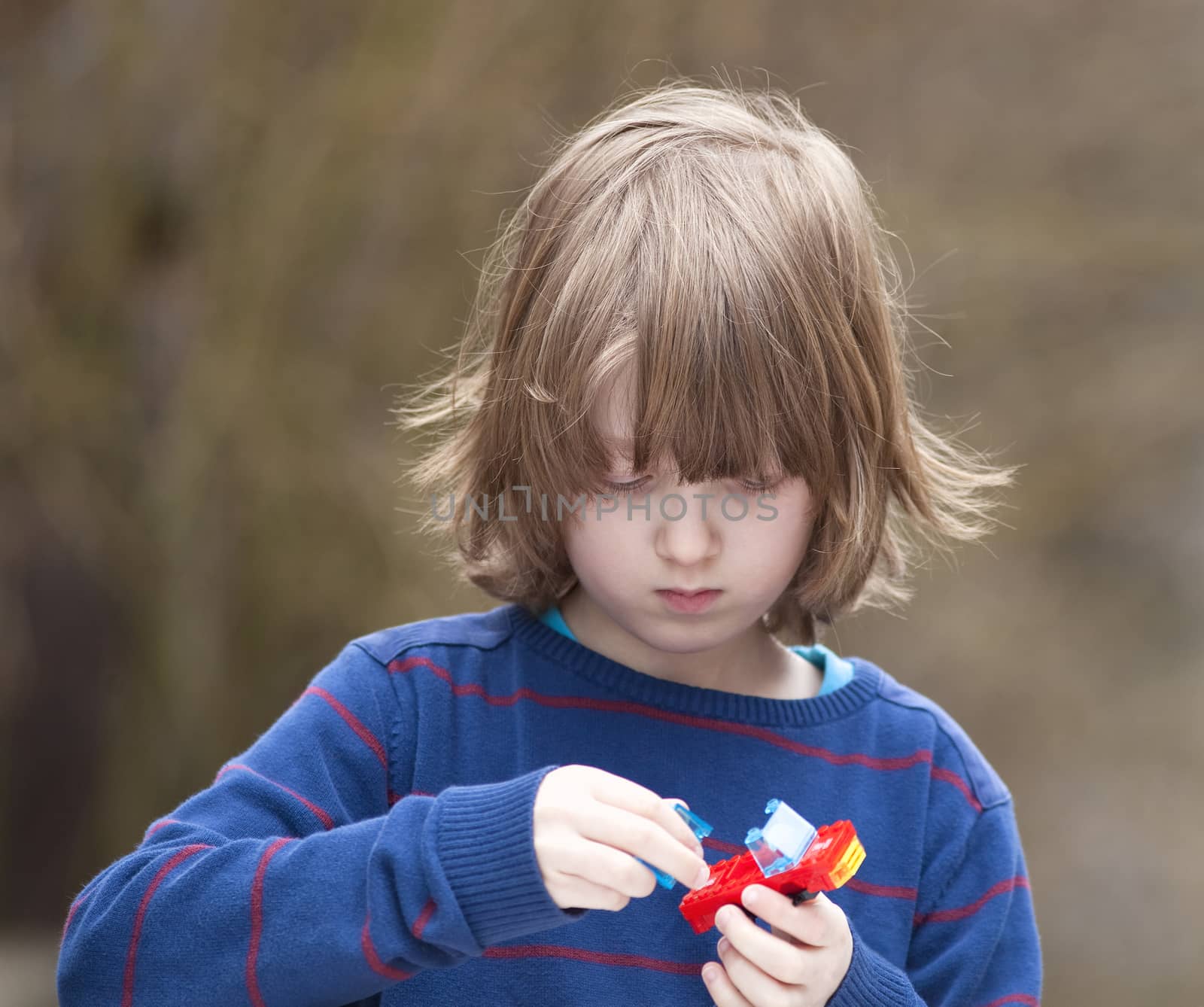 Boy Putting Together his Assembling Toys by courtyardpix