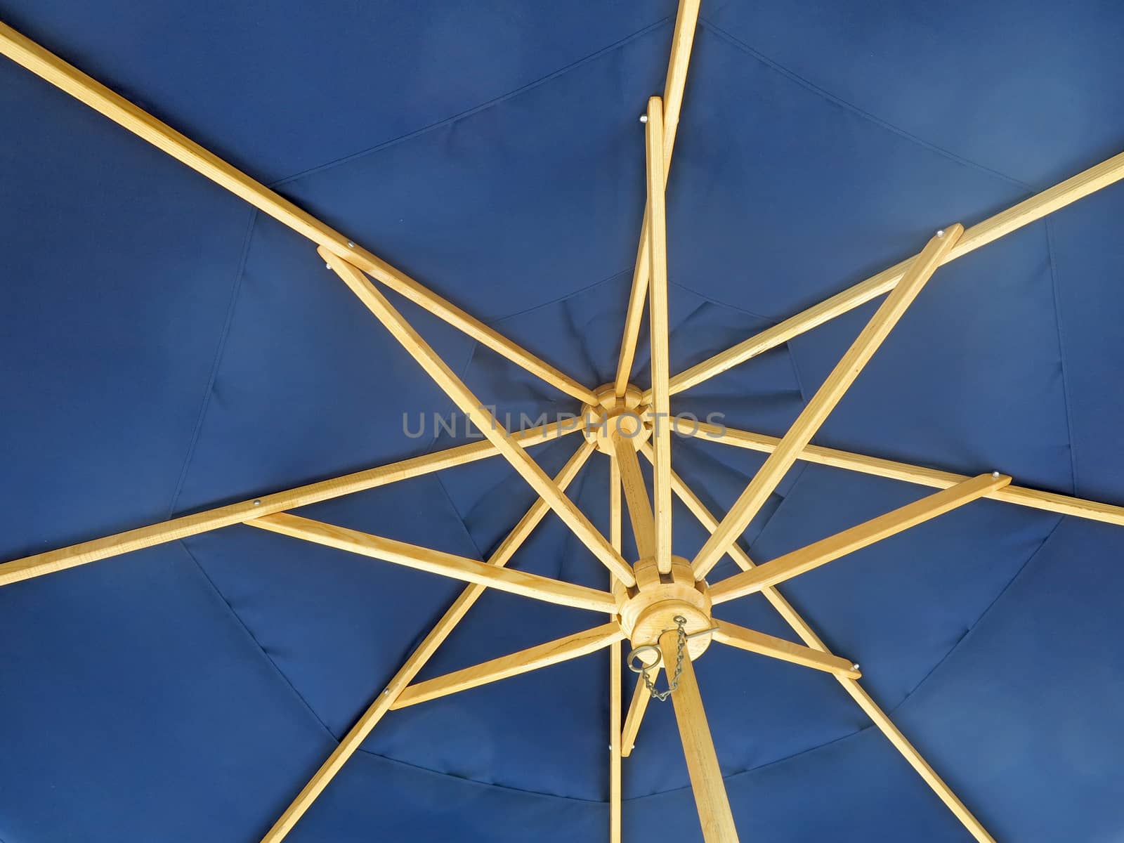 The inside on an open blue umbrella
