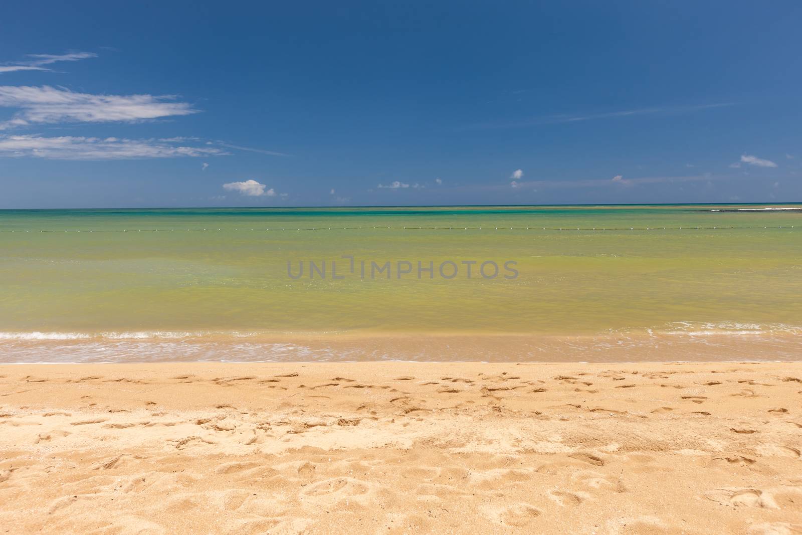 Beach on the tropical island. Clear blue water, sand and clouds. Beautiful vacation spot.