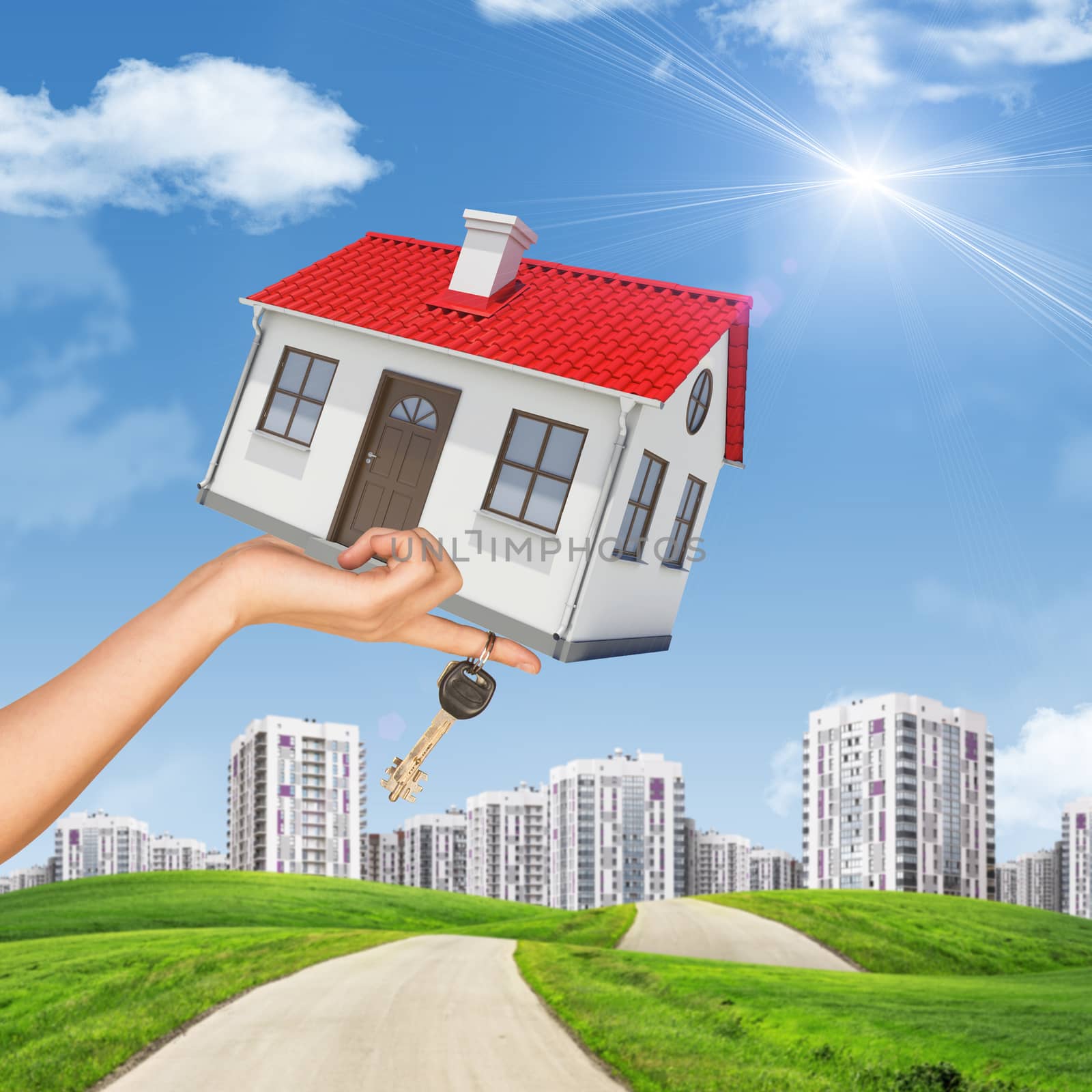 House and keys in womans hand on cityscape background with blue sky
