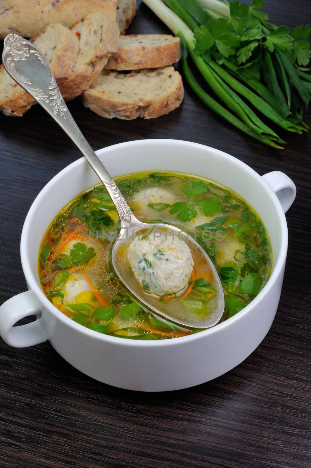 Easy chicken soup with meatballs, green onions and parsley