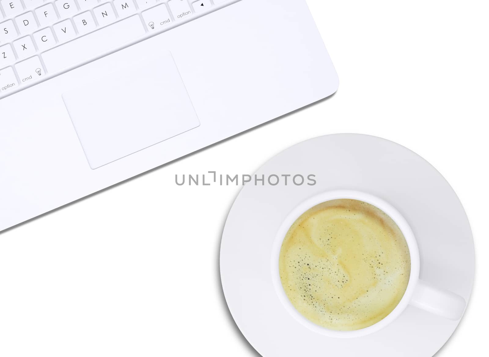 Part of white laptop and cup with coffee on plate on isolated white background, top view. Closed up