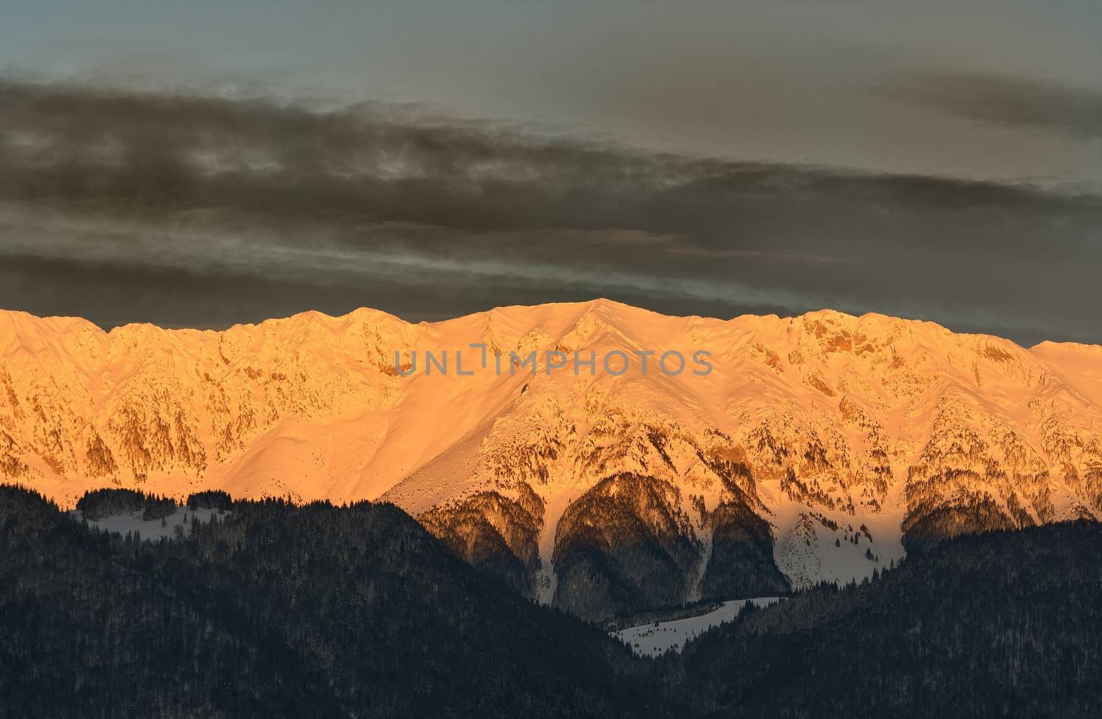 Mountain range lit by the rising sun. Piatra Craiului mountains.