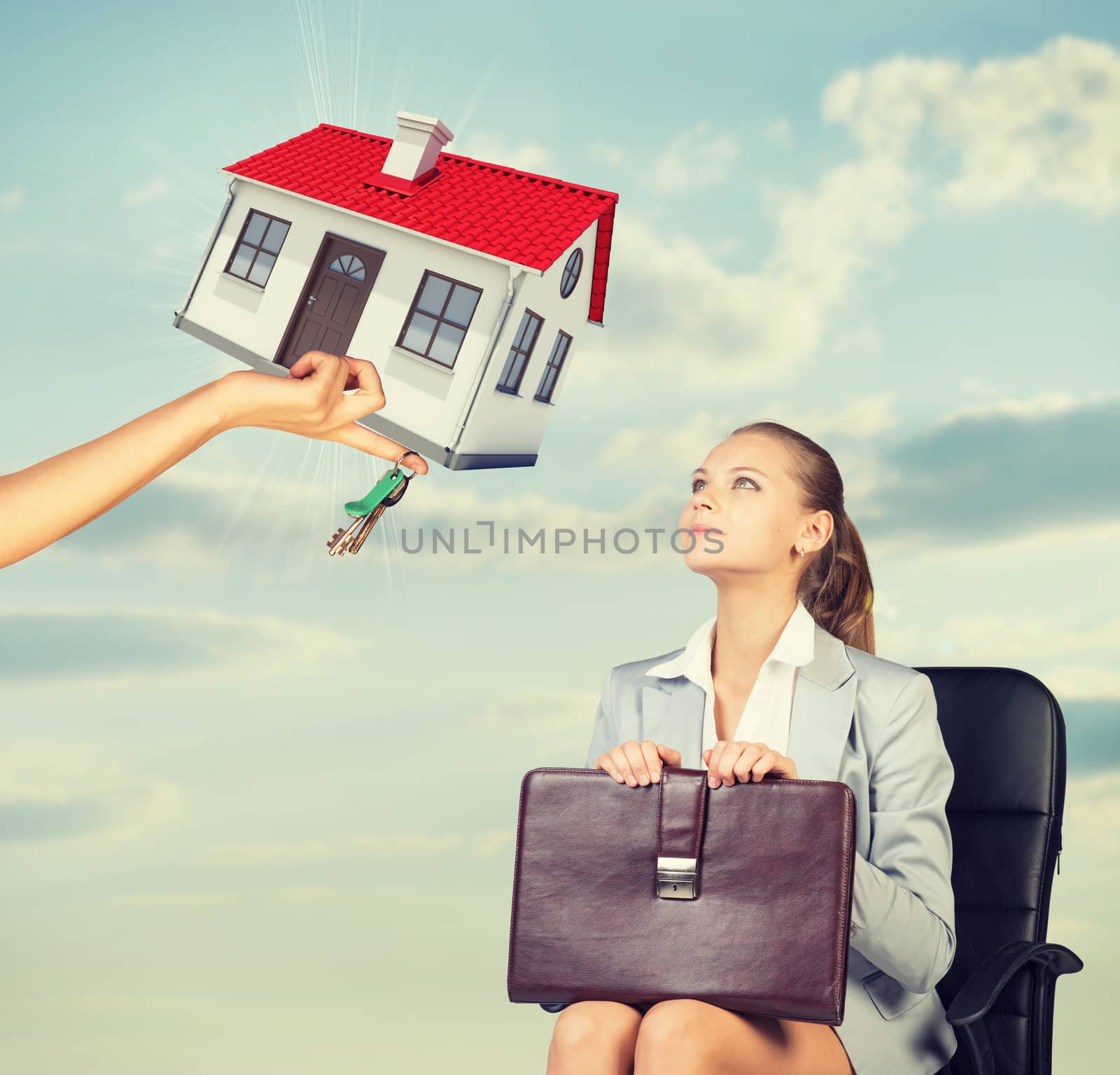 Businesswoman sitting in the chair and looking up at womans hand offering house and keys