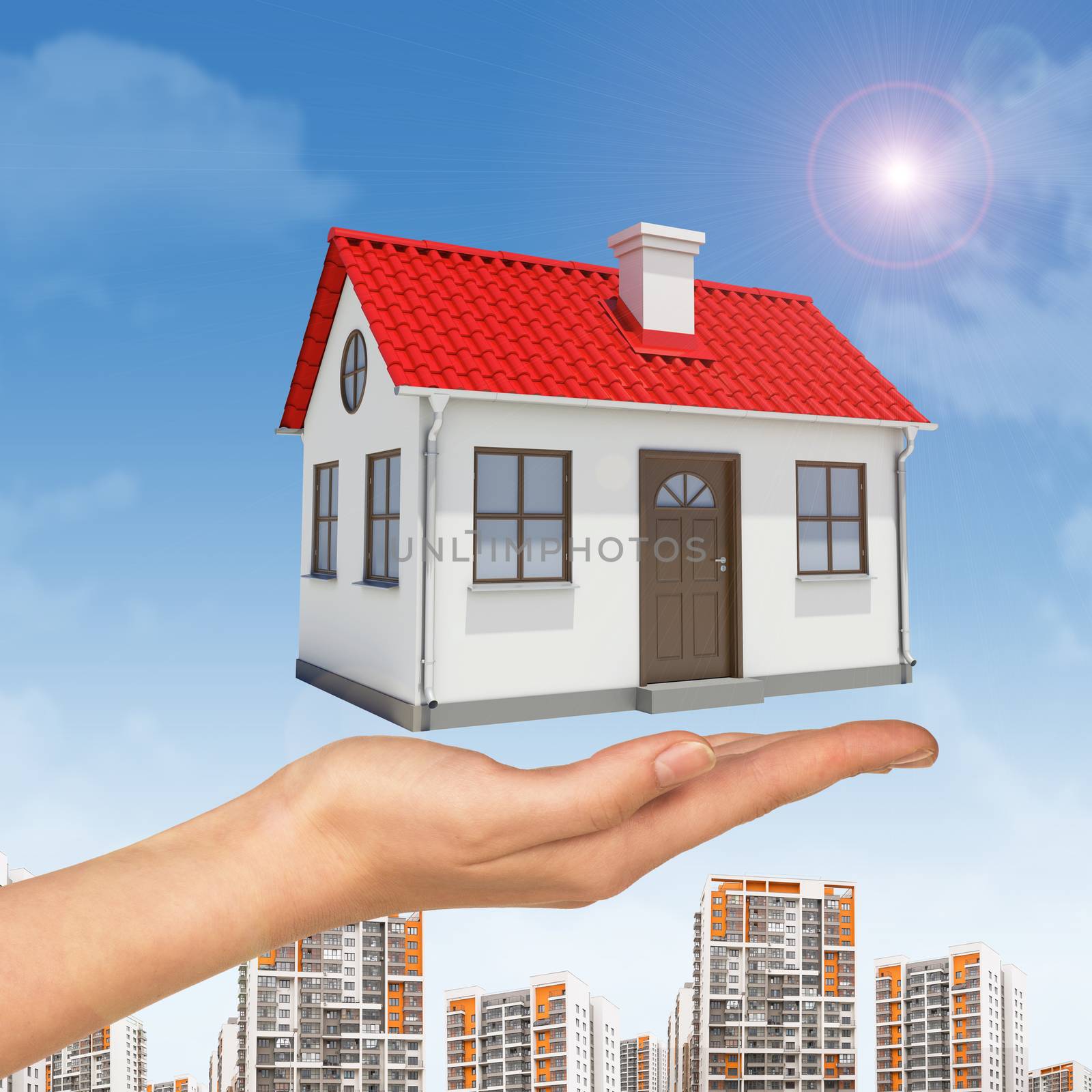 House under businesswomans hand with cityscape on blue sky background 