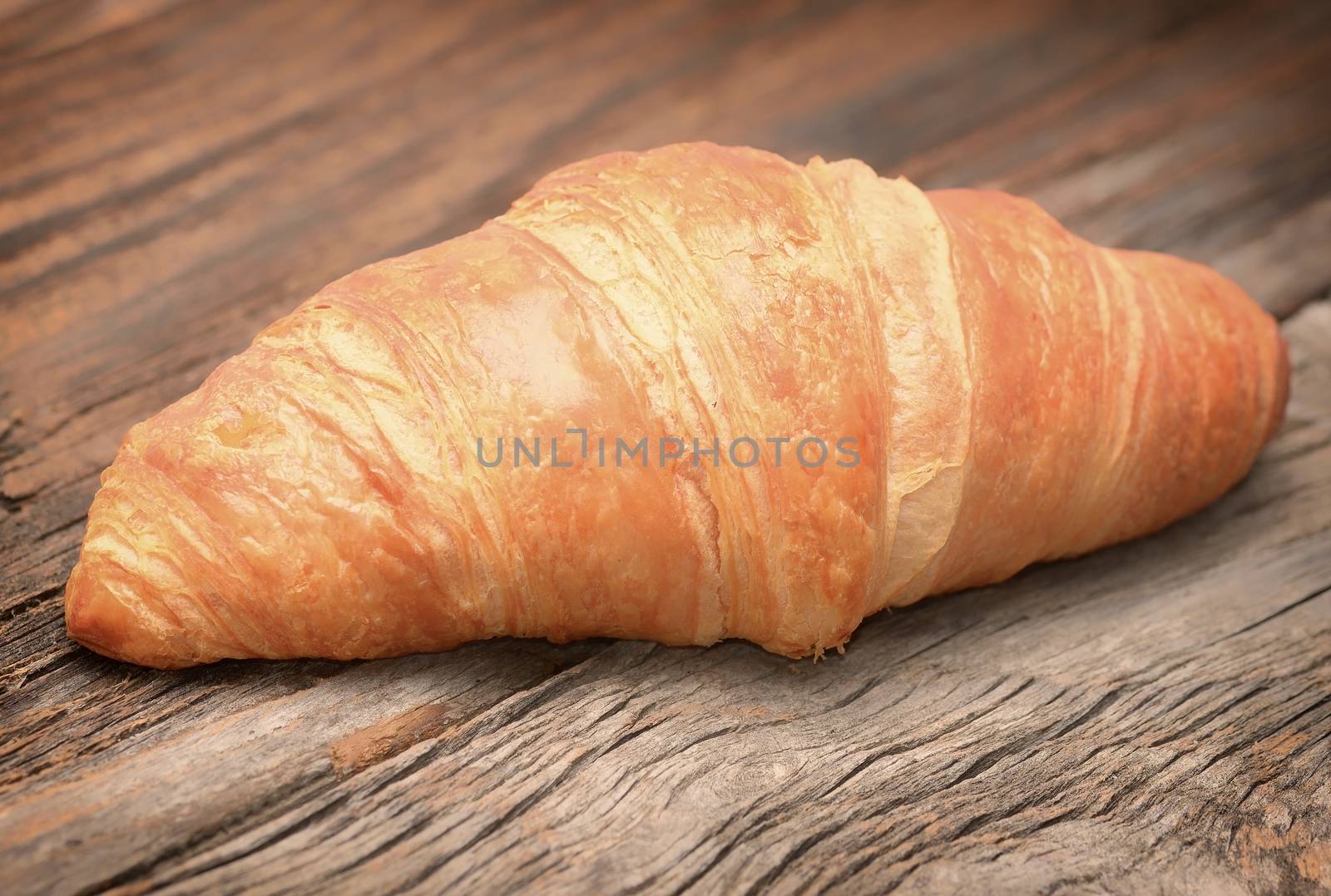 Croissants on the wooden table by comet