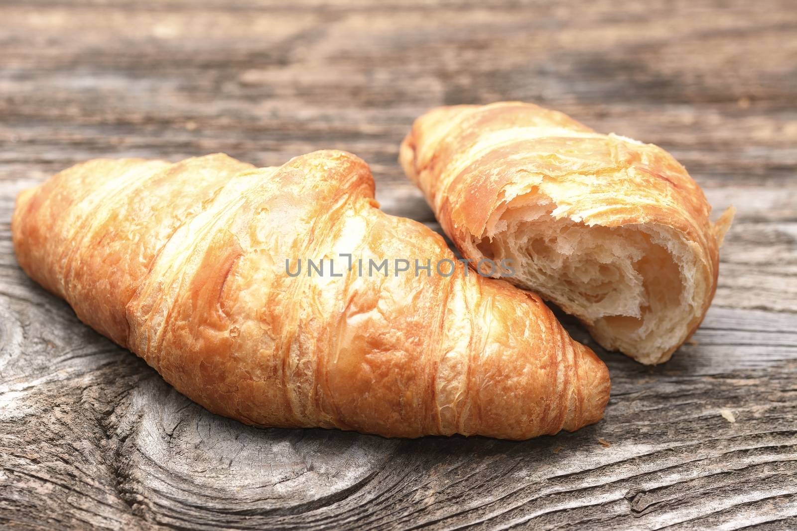 Croissants on the wooden table by comet