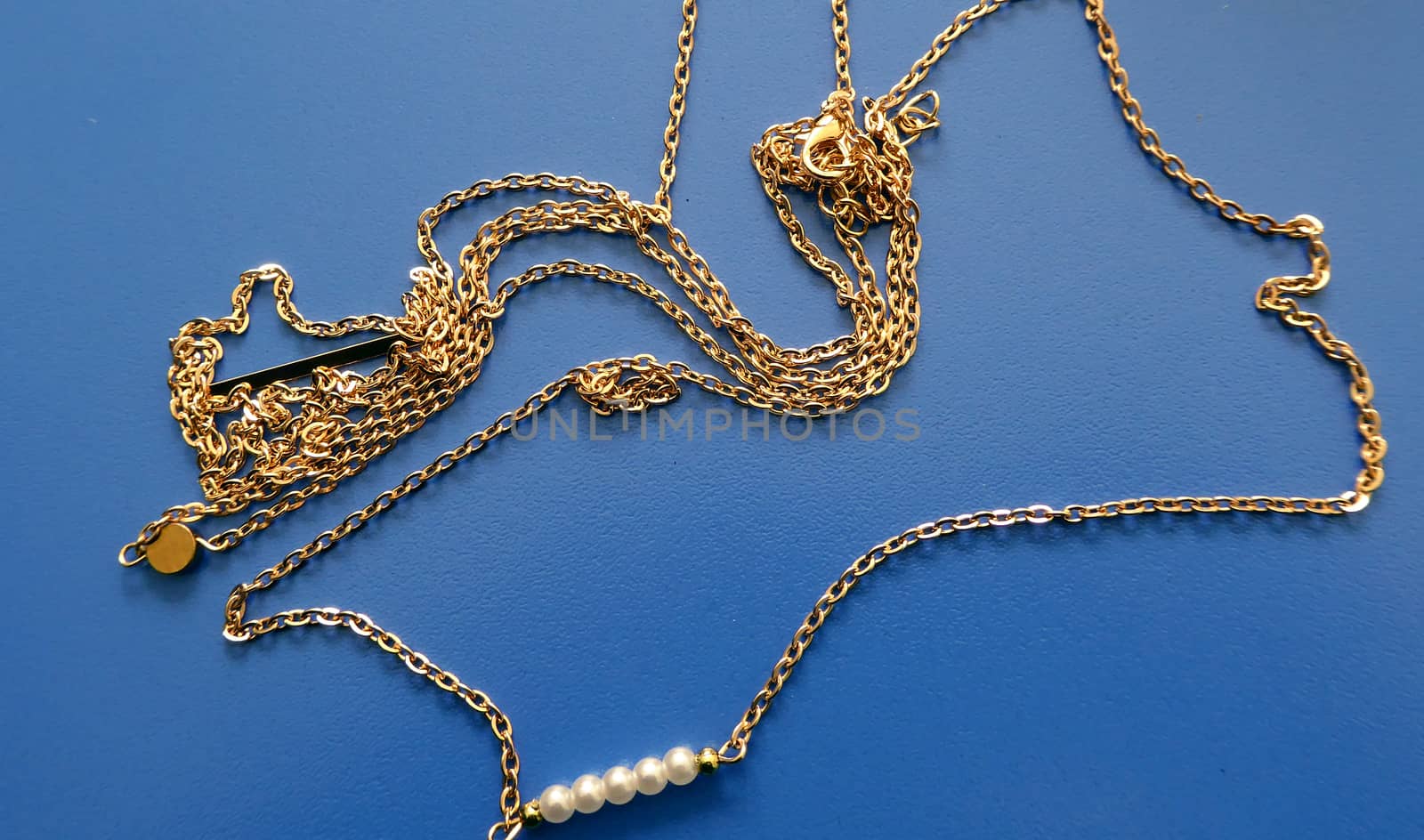 Fashion trendy necklace on a blue background, photo of