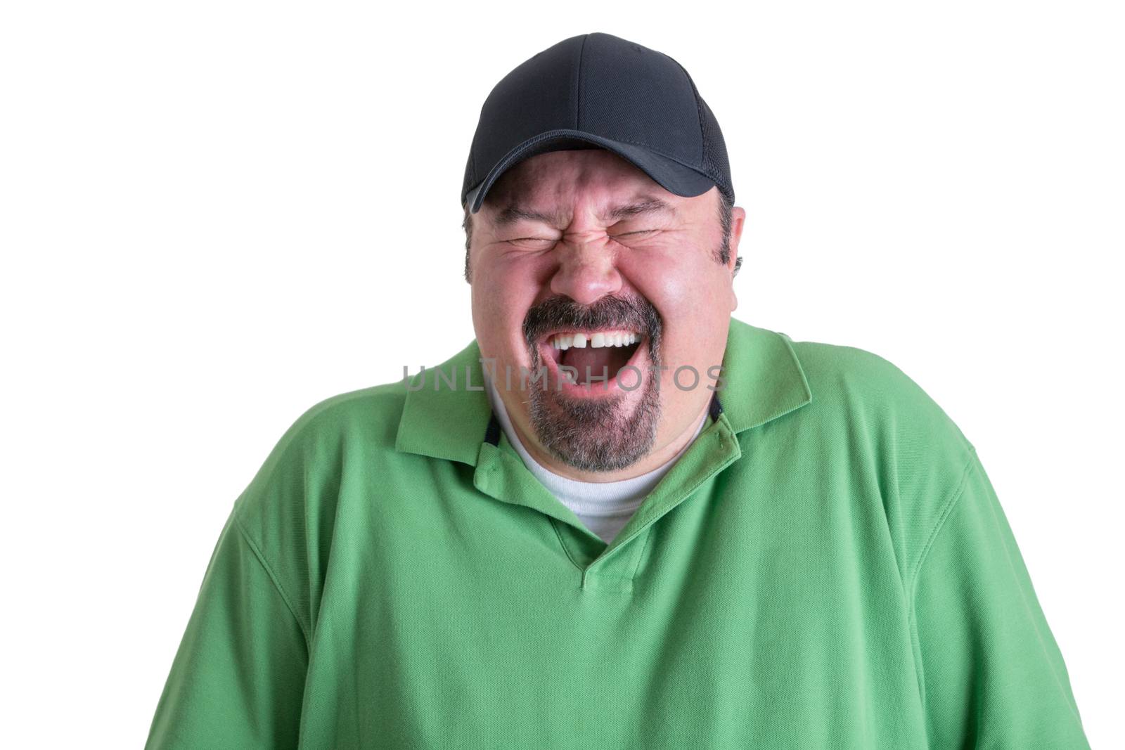 Portrait of Overweight Man Wearing Green Shirt and Black Baseball Cap Laughing Ecstatically in front of White Background, Head and Shoulders Portrait of Joyful Man