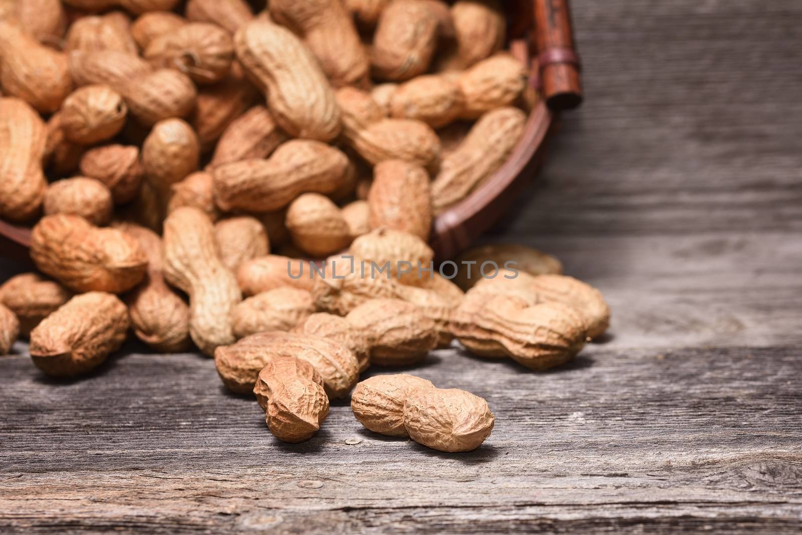 Peanuts in shells on wooden background