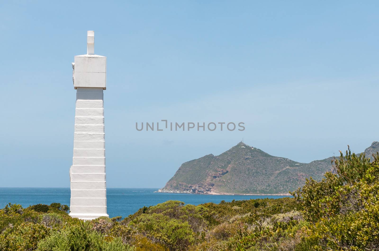 Monument near Cape Point (visible in back) commemorate voyage around the Cape by Vasco da Gama in 1497. Serves as beacon helping ships avoid Whittle Rock