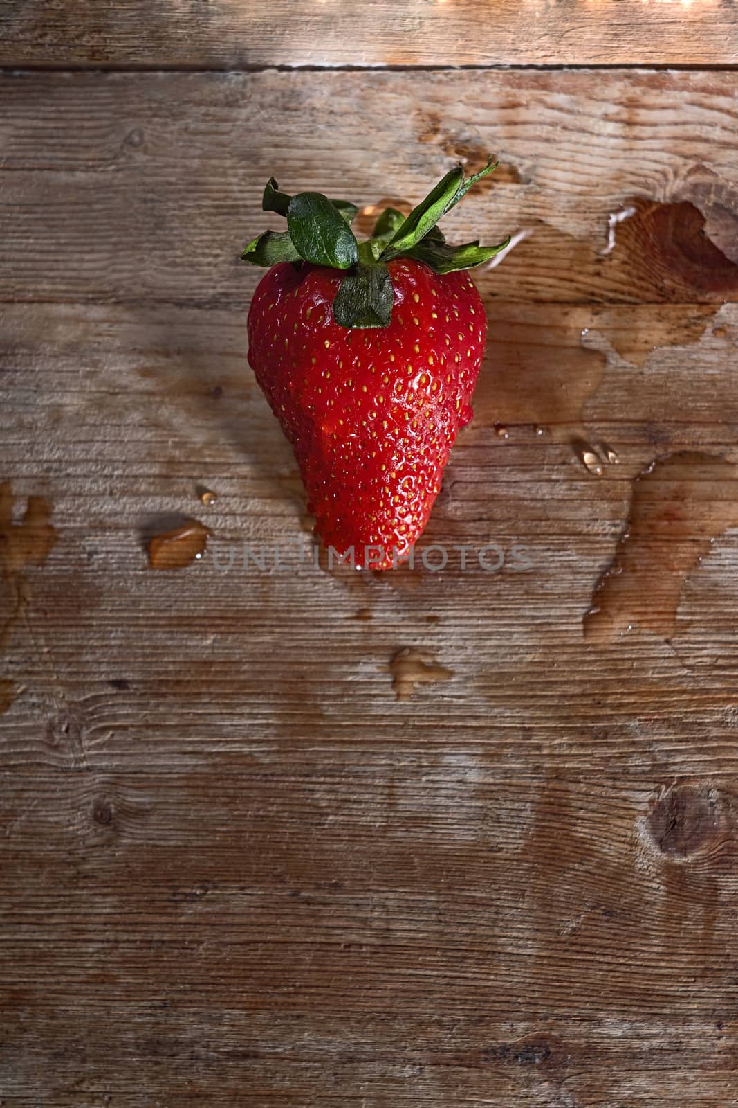 strawberry on the basis of wood and water drops