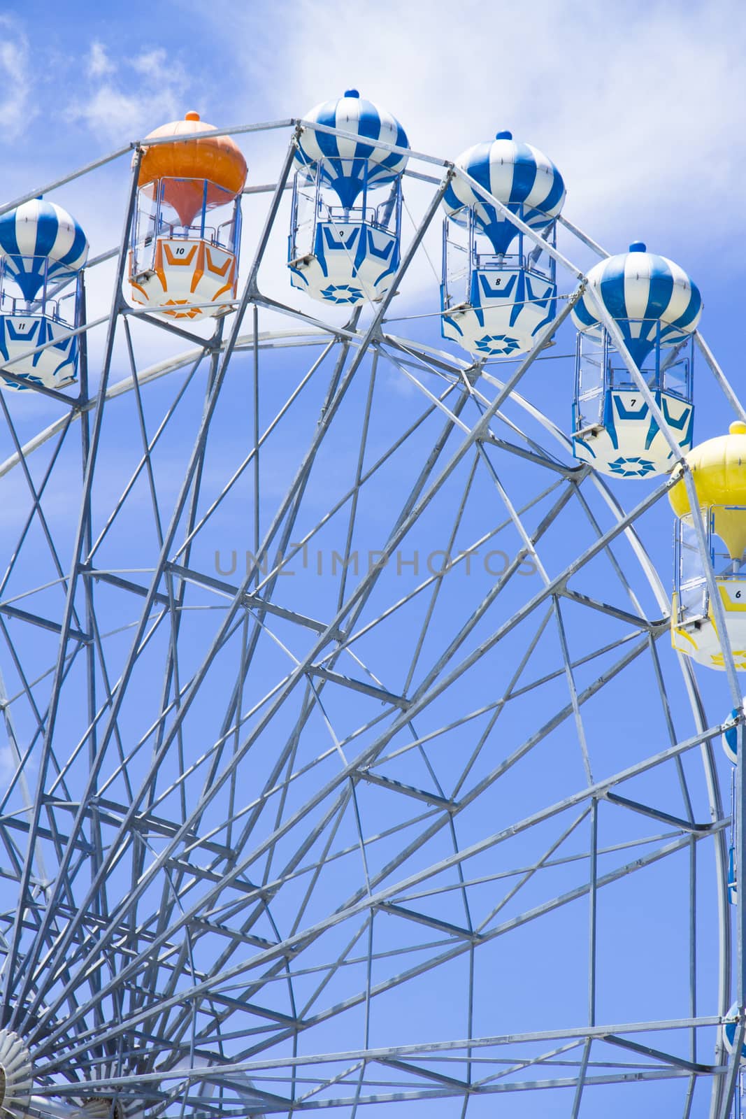 Giant ferris wheel against blue sky and white cloud