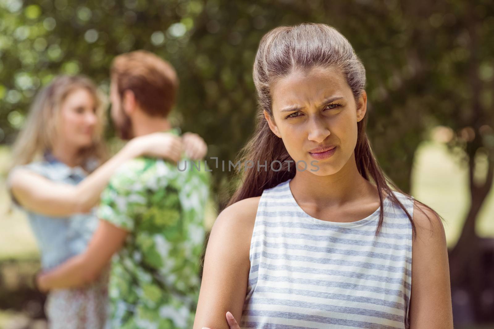 Brunette upset at seeing boyfriend with other girl on a summers day