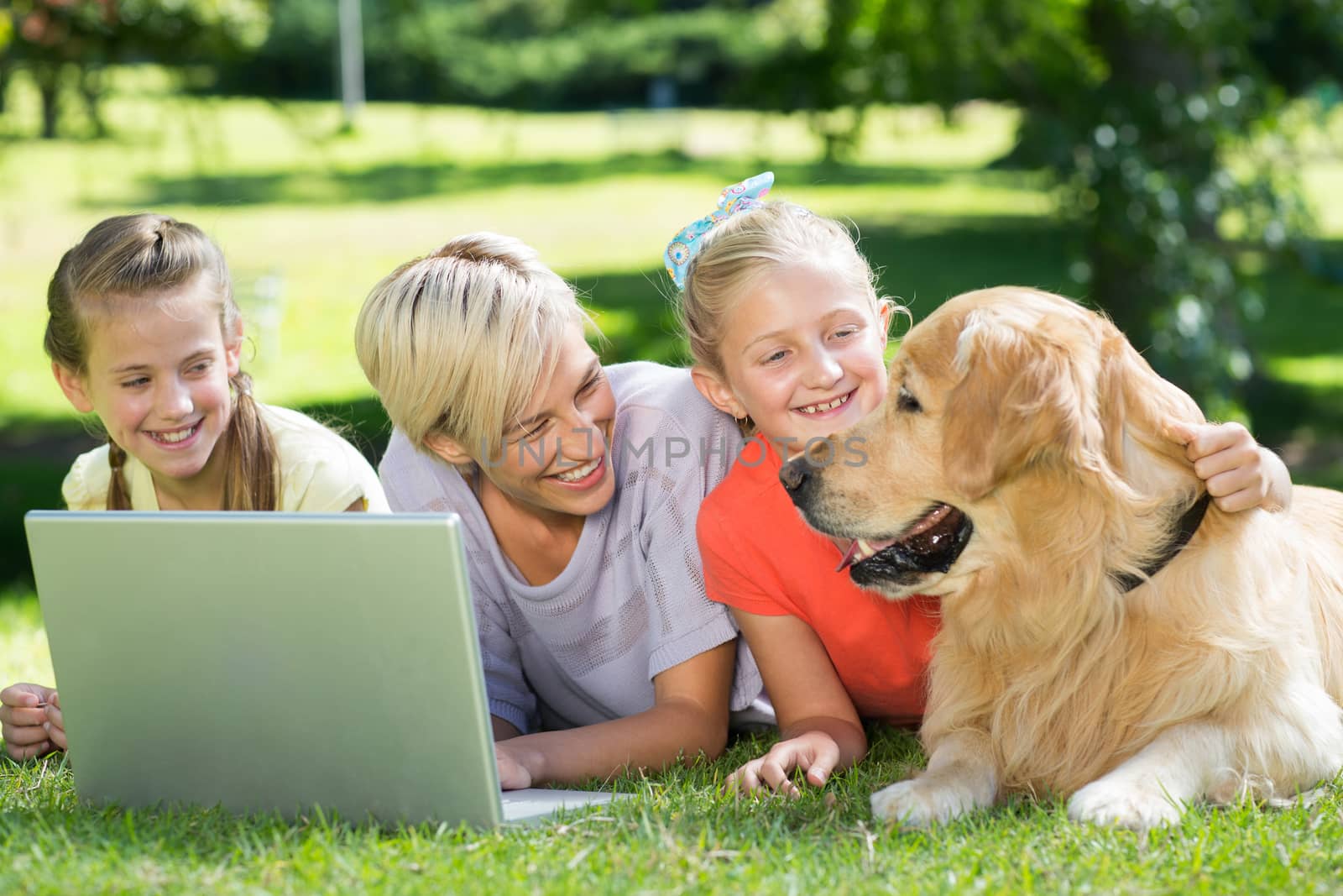 Happy family looking at their dog  by Wavebreakmedia