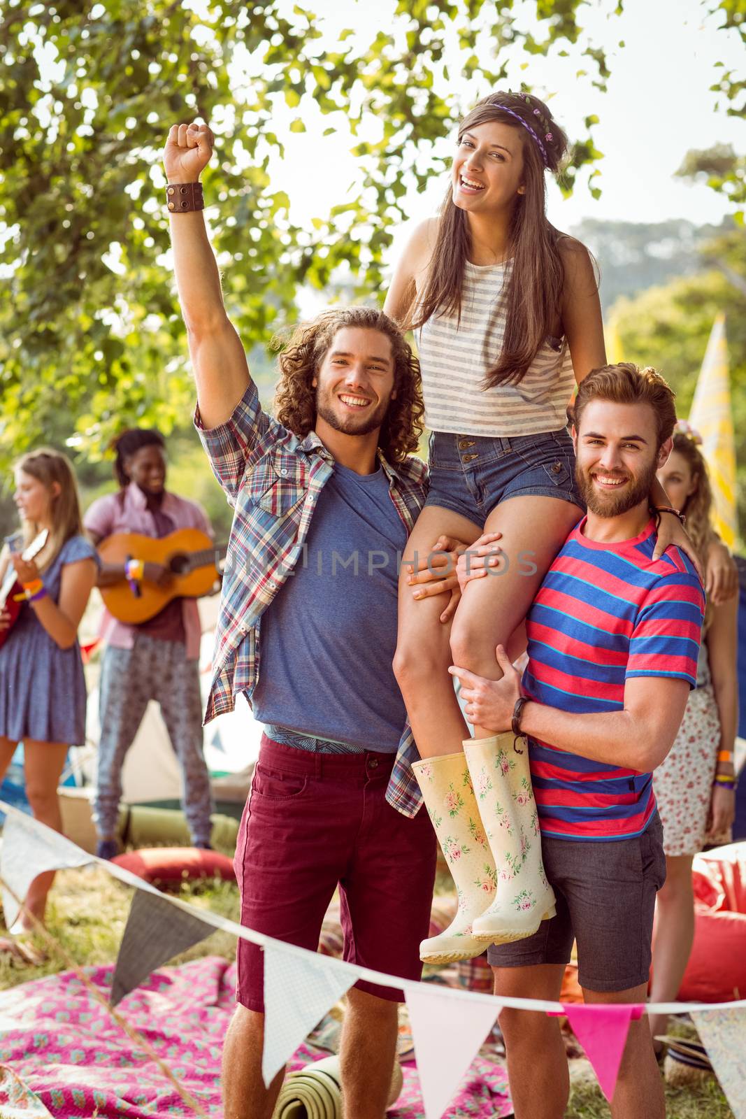 Pretty hipster on friends shoulders at a music festival 