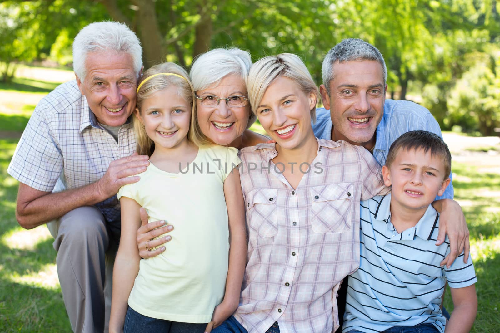 Happy family smiling at the camera  by Wavebreakmedia