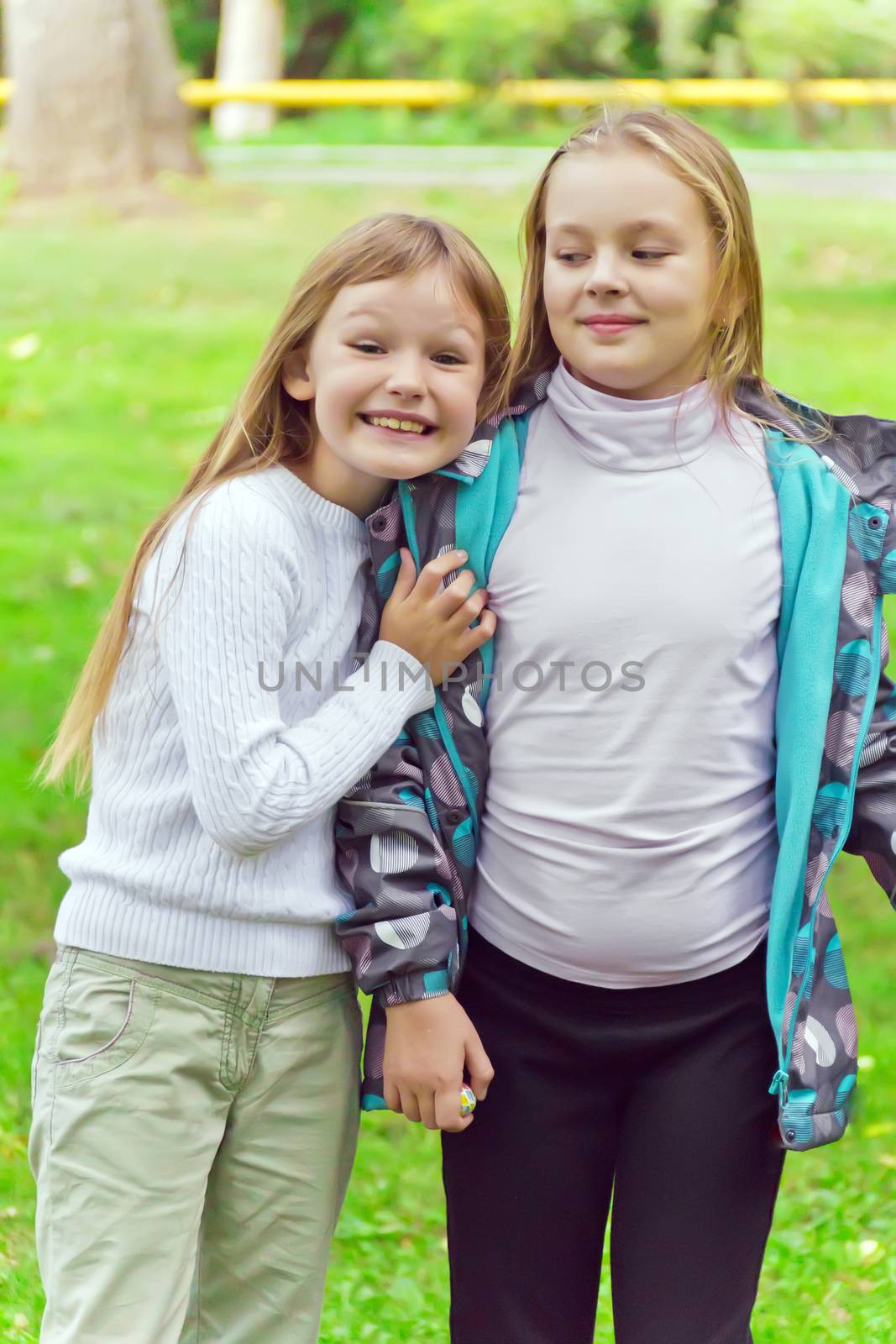 Photo of two playing girls in summer