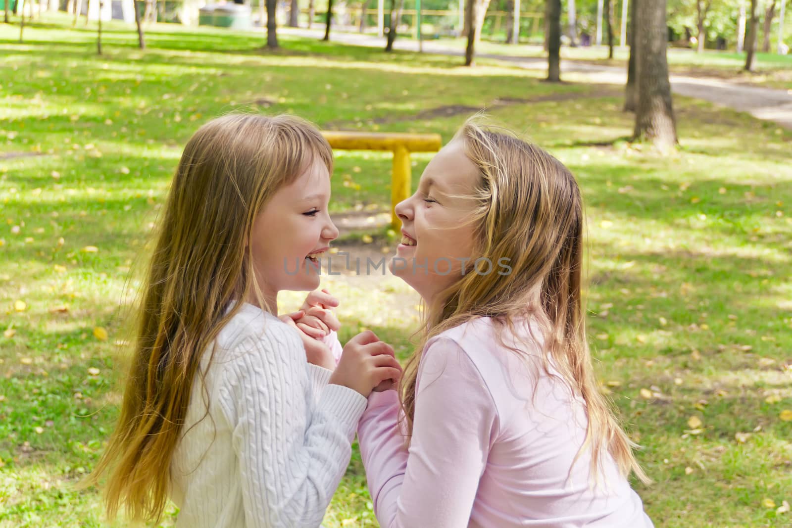 Photo of two playing girls in summer