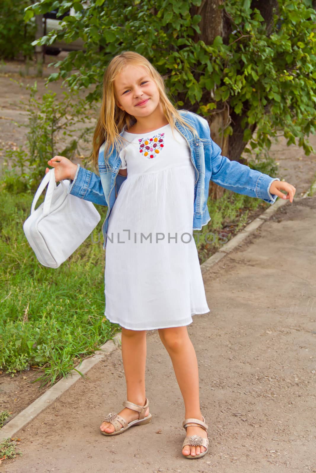 Cute girl playing with white bag in summer