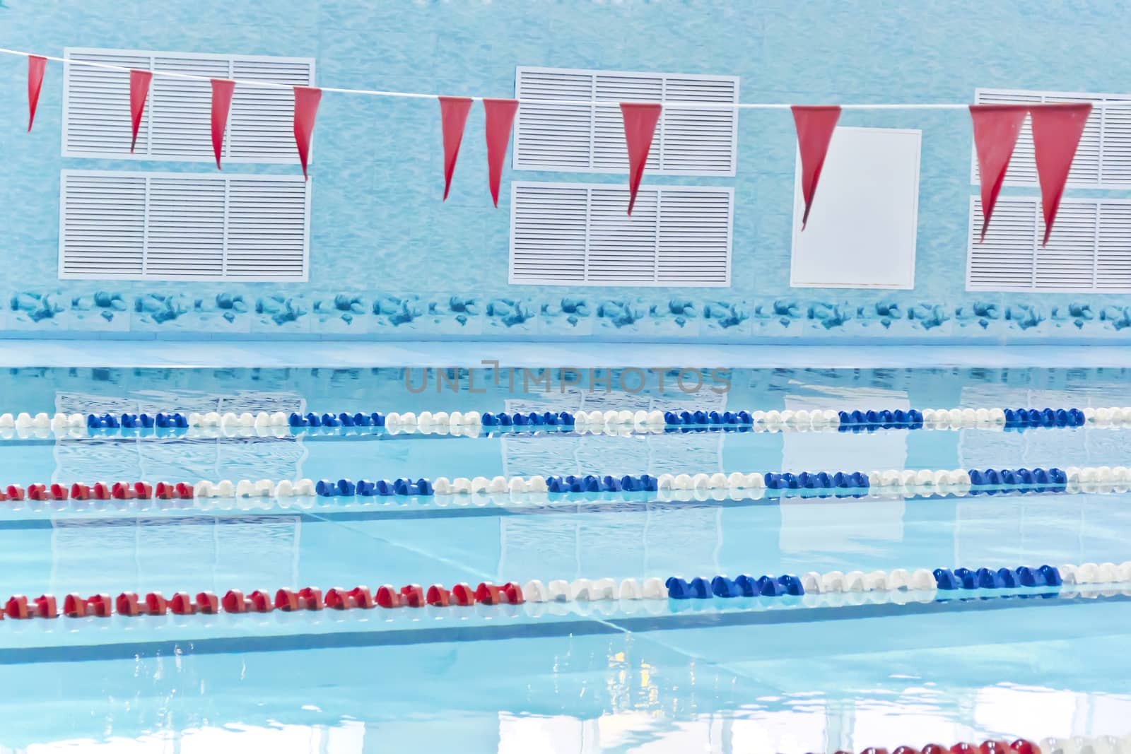 Photo of empty swimming pool with red flags
