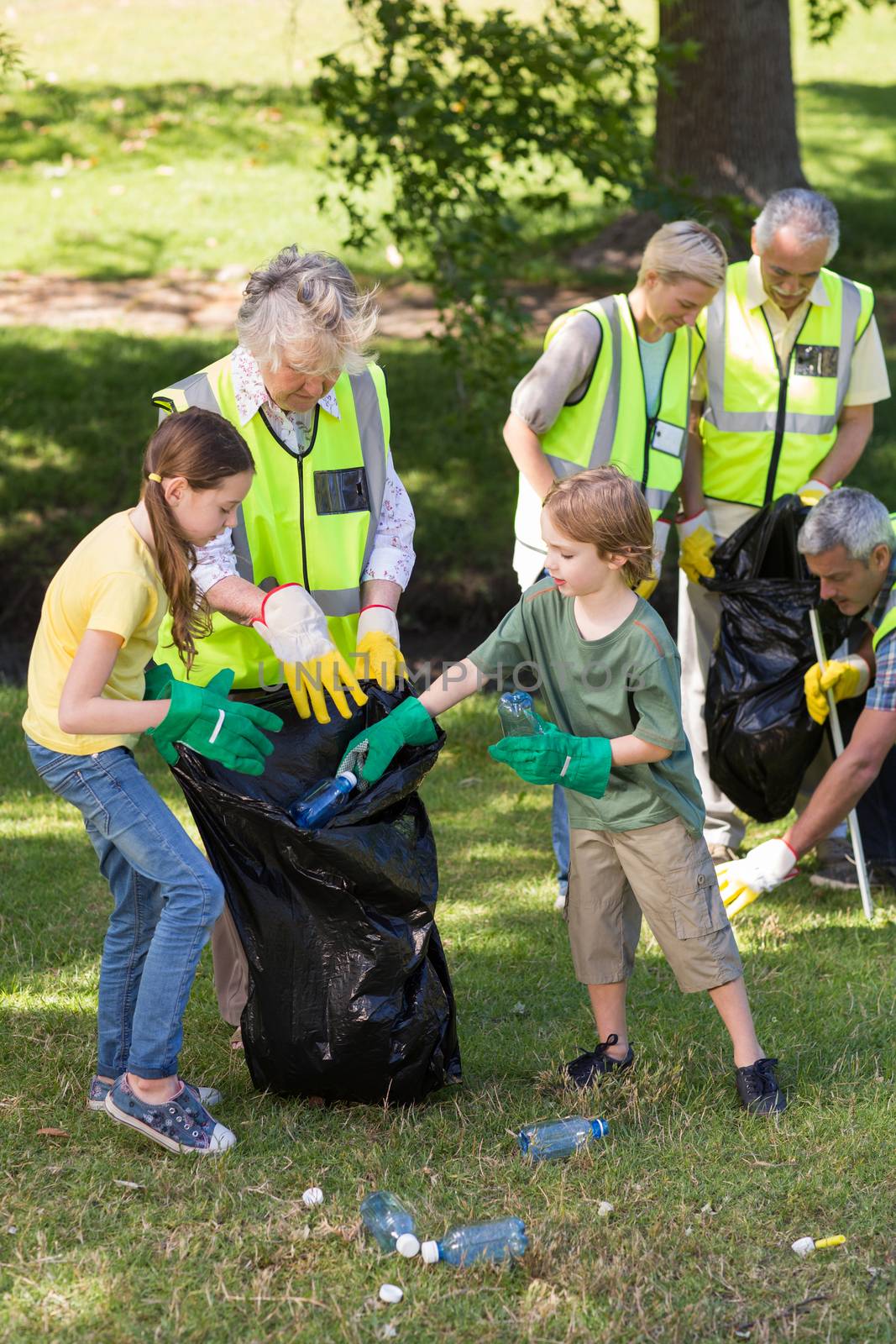 Happy family collecting rubbish  by Wavebreakmedia