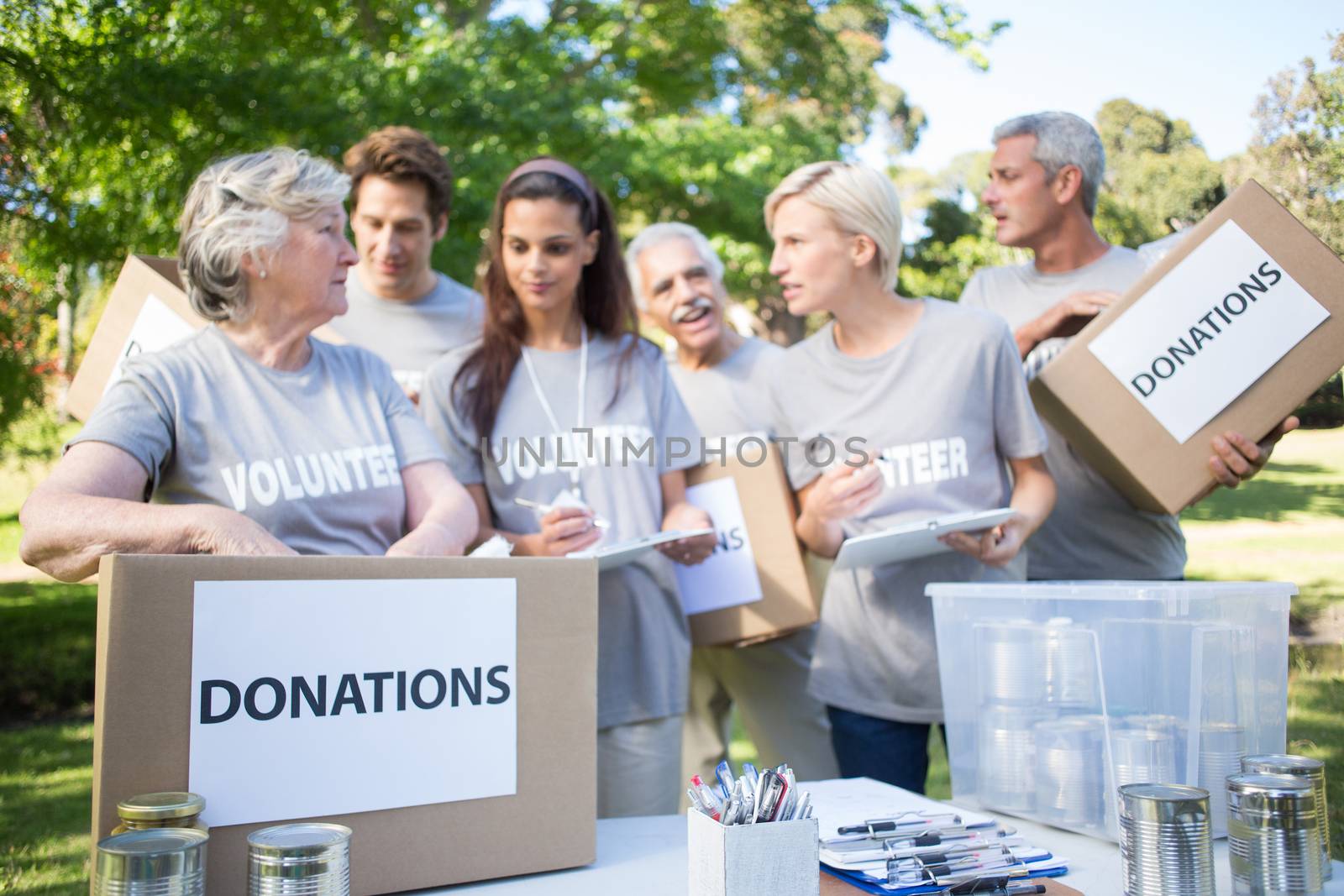 Happy volunteer family holding donation boxes  by Wavebreakmedia